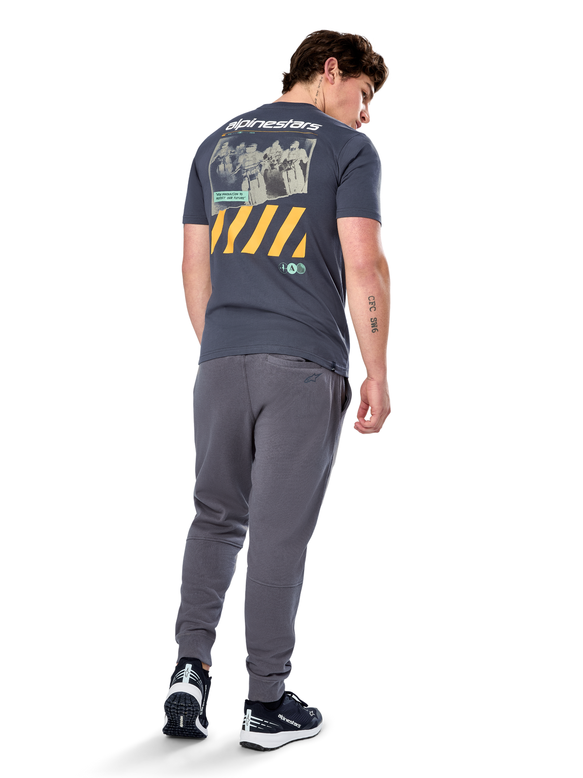 Alpinestars No Barrier CSF Tee, Short Sleeve T-Shirt, Charcoal, Back view featuring large distressed photo graphic with yellow diagonal stripes and white logo, casual motorsport-inspired streetwear