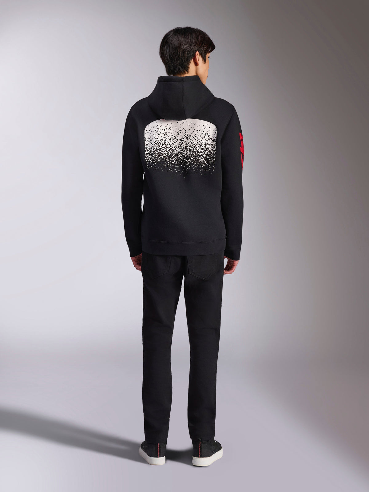 Alpinestars Obsessed Hoodie, casual sportswear, black with white MX gradation back graphic, red word logo on the sleeve, back view, worn with black pants.
