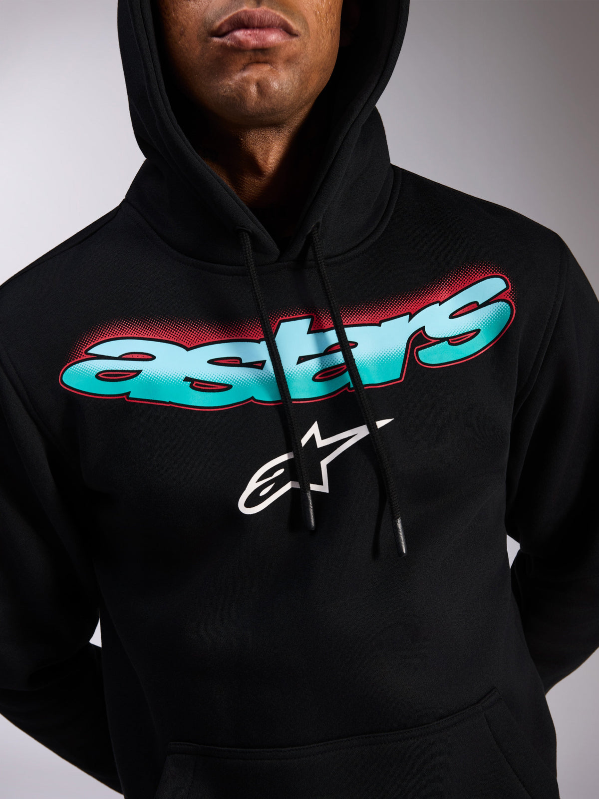 Alpinestars Ellipsoid Hoodie, black pullover fleece, teal and blue color gradient Astars wordmark with red halftone accents, white star logo, drawstring hood, casual motorsport-inspired streetwear