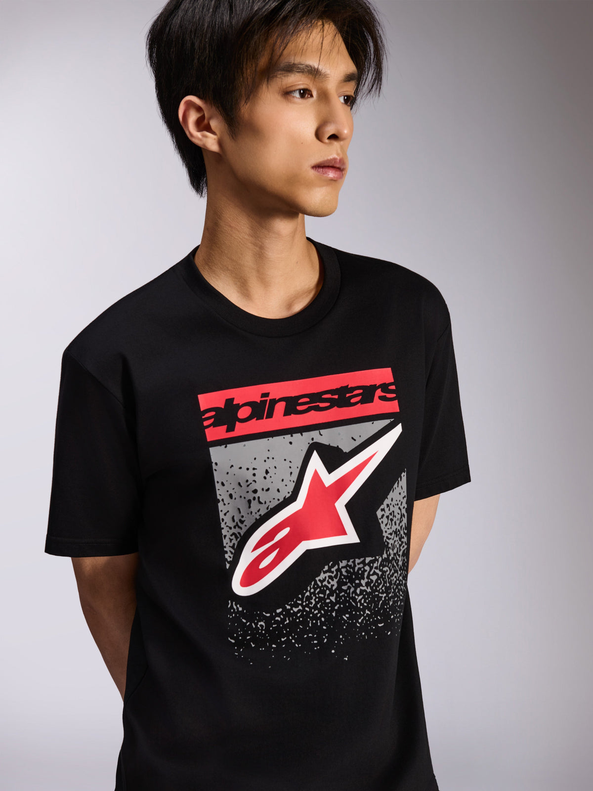 Alpinestars Noka CSF Tee, Short Sleeve T-Shirt, Black, featuring a red branding block and large red and white Astars logo with a grey textured background, Casual Motorsport Streetwear