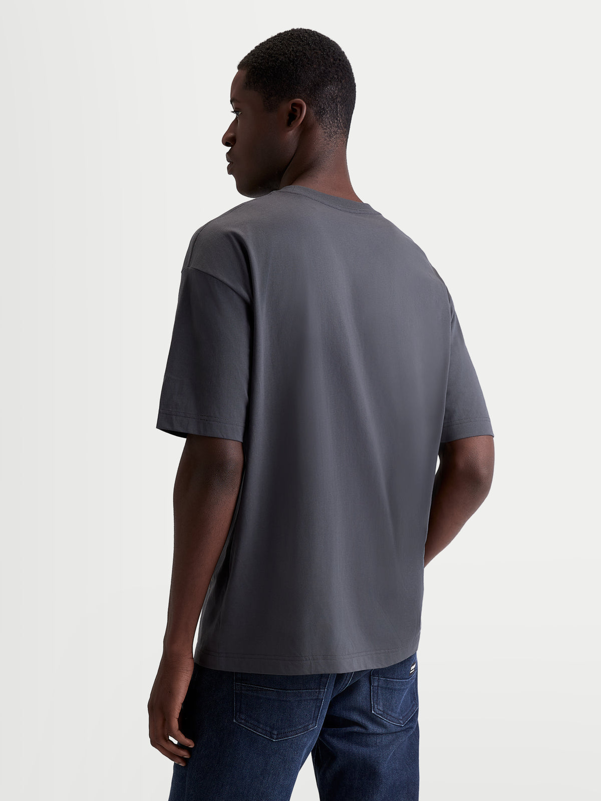 Alpinestars Chalk Oversized CSF Tee, Men's and Women's Casual Sportswear T-Shirt, Charcoal Gray, rear three-quarter view on model showing the relaxed oversized fit and premium cotton-poly blend construction.