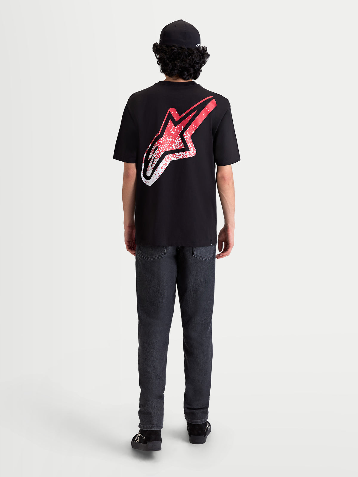 Alpinestars Meteor CSF Tee, Short Sleeve Sportswear T-Shirt, Black, Red, and White. On-model rear view featuring a large back Astars logo with an MX-inspired red and white gradient graphic.