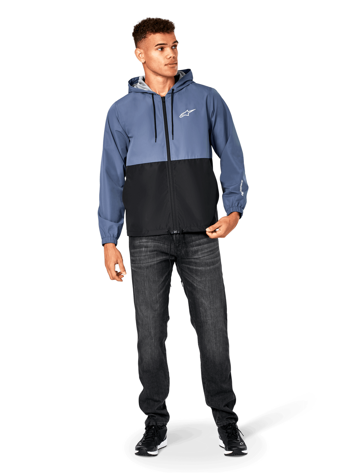 Alpinestars Speeder Windbreaker Jacket, Slate Blue and Black, hooded lightweight jacket with mesh lining, white star logo on chest, worn with black jeans and sneakers, casual motorsport streetwear design.