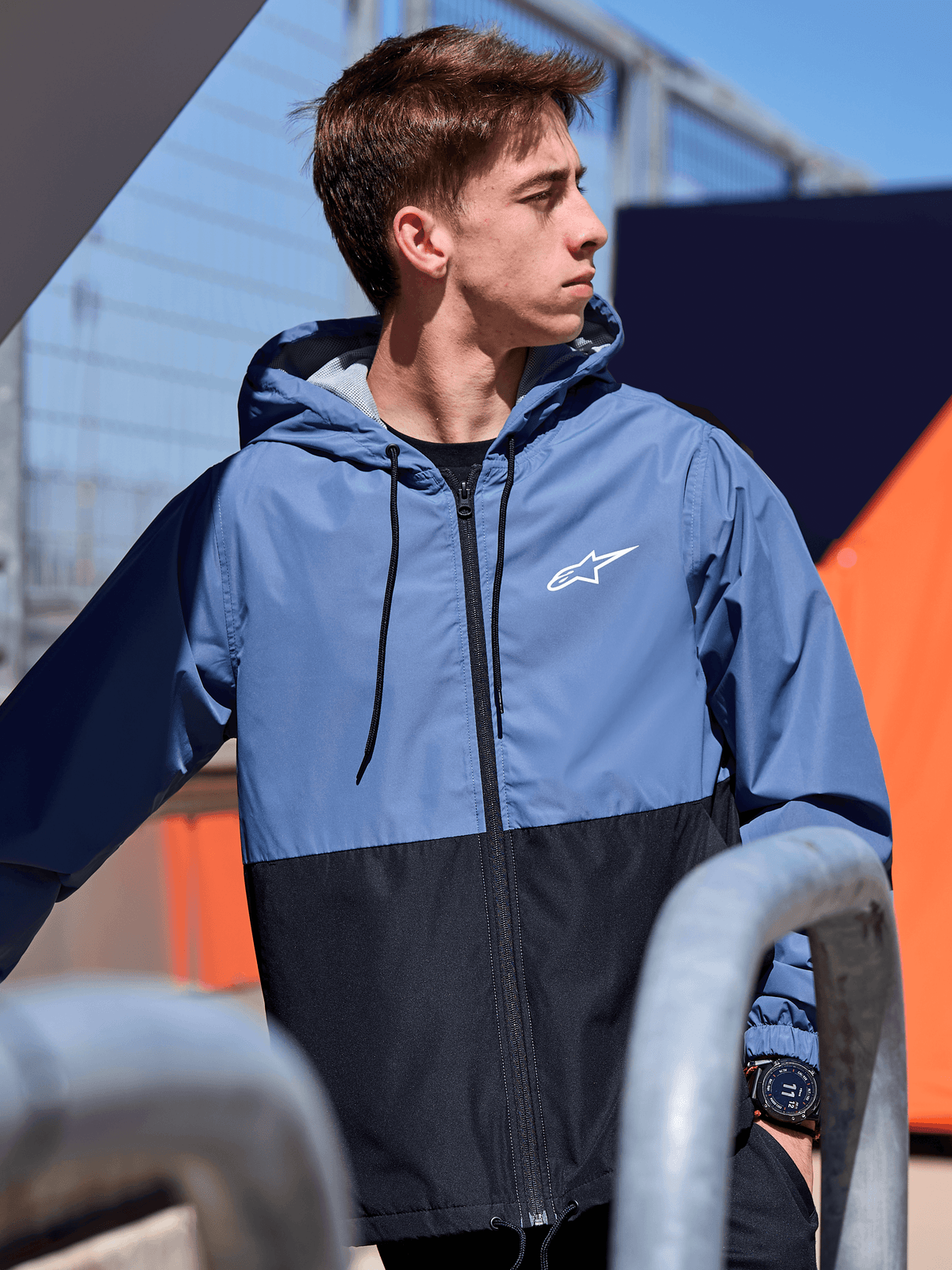 Alpinestars Speeder Windbreaker Jacket, lightweight hooded windbreaker, Slate Blue and Black color-blocked design, white Alpinestars logo on the chest, mesh-lined with drawstring hood, casual motorsport-inspired streetwear