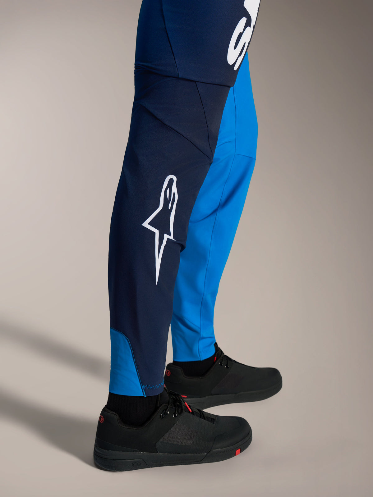 A-Supra Elite MTB Pants in faded bright blue, featuring a bold white Astars logo and slim-fit racing construction.