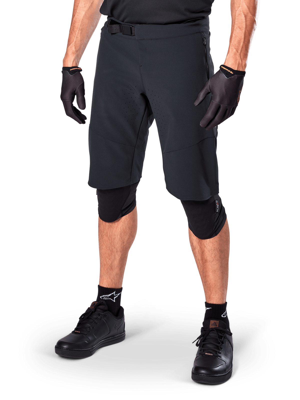 Alpinestars A-Aria Elite Shorts, Black Cycling Shorts, worn with matching black gloves and knee guards, featuring a magnetic buckle and laser-cut perforations, sleek design for off-road mountain biking