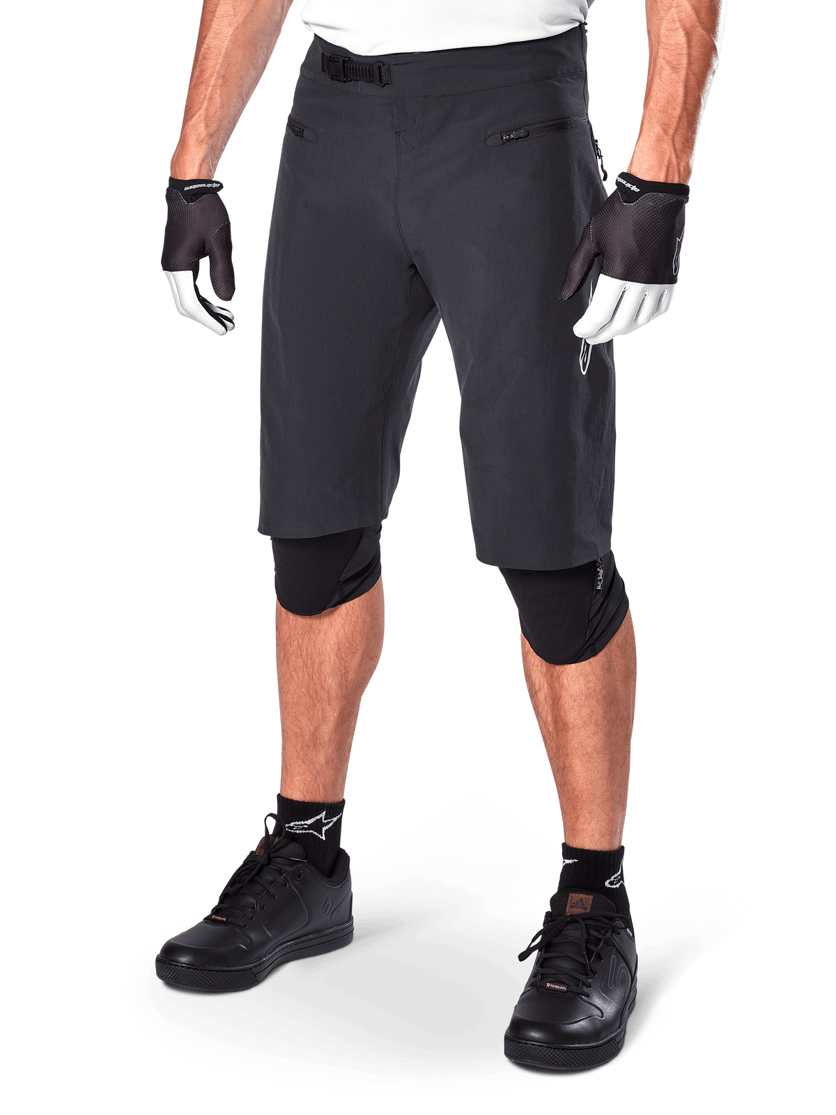 Alpinestars A-Aria Shorts, Mountain Biking Shorts, Black, knee-length with front zippered pockets and adjustable ratchet waist buckle, worn with black knee pads, socks, and cycling gloves