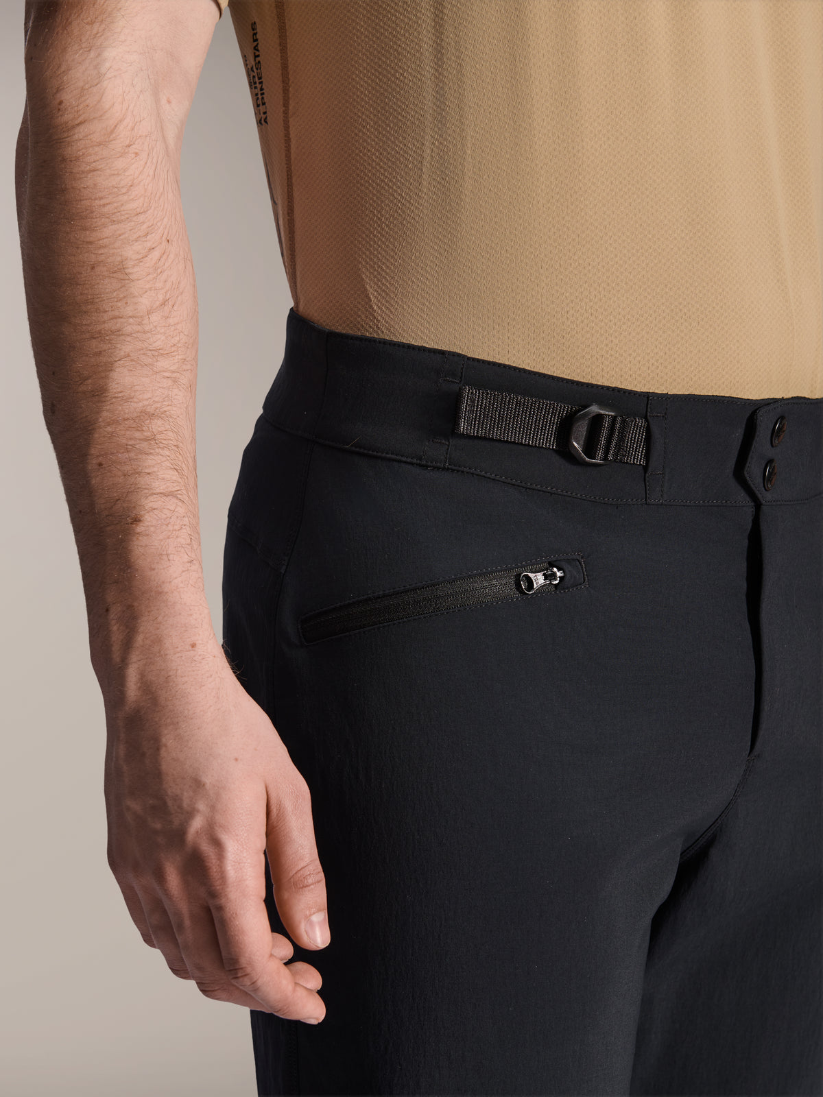Alpinestars A-Dura Shorts, Black MTB shorts, close-up view showing zippered pocket and adjustable side cinch strap, double snap closure, durable fabric for mountain biking