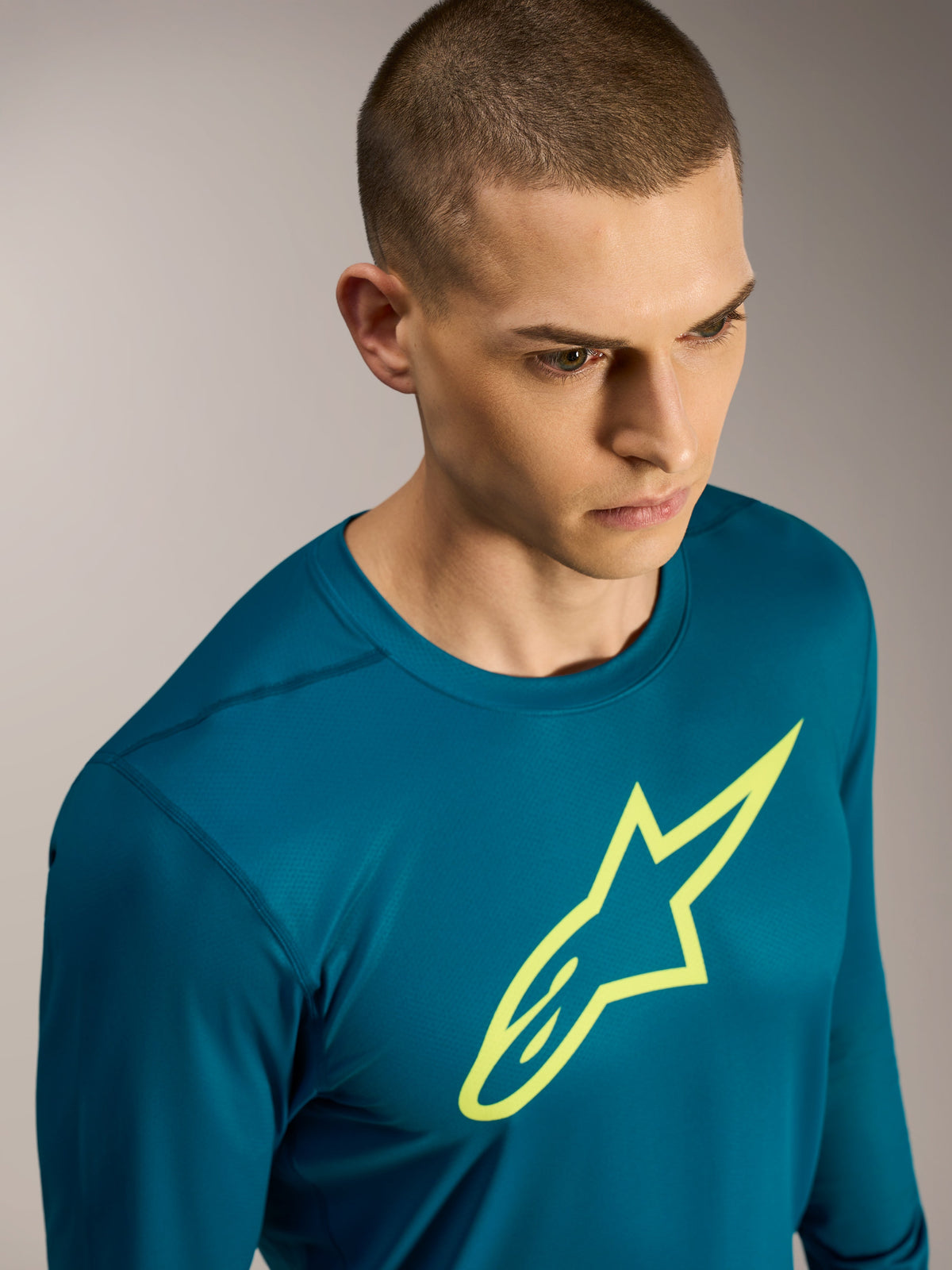 Alpinestars A-Dura Ride Long Sleeve Jersey, blue-green MTB top with a yellow Astars logo and performance stretch fabric