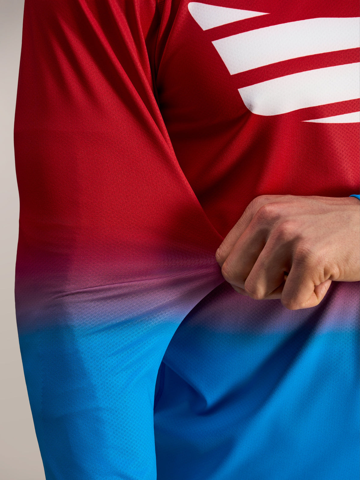 Flexible red and blue poly-spandex fabric on the Alpinestars A-Dura ASTARS 2.0 Long Sleeve Jersey.
