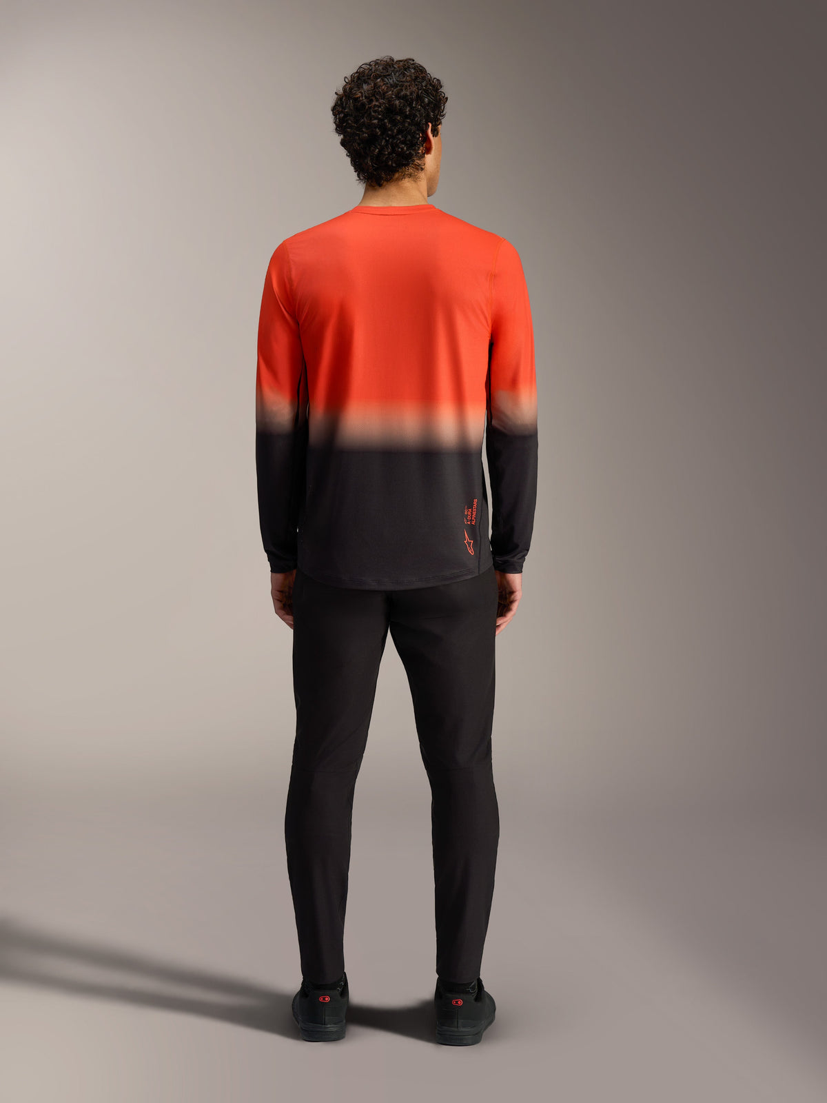 A-Dura ASTARS Jersey 2.0 in orange and black gradient, rear view of the long sleeve mountain bike jersey.