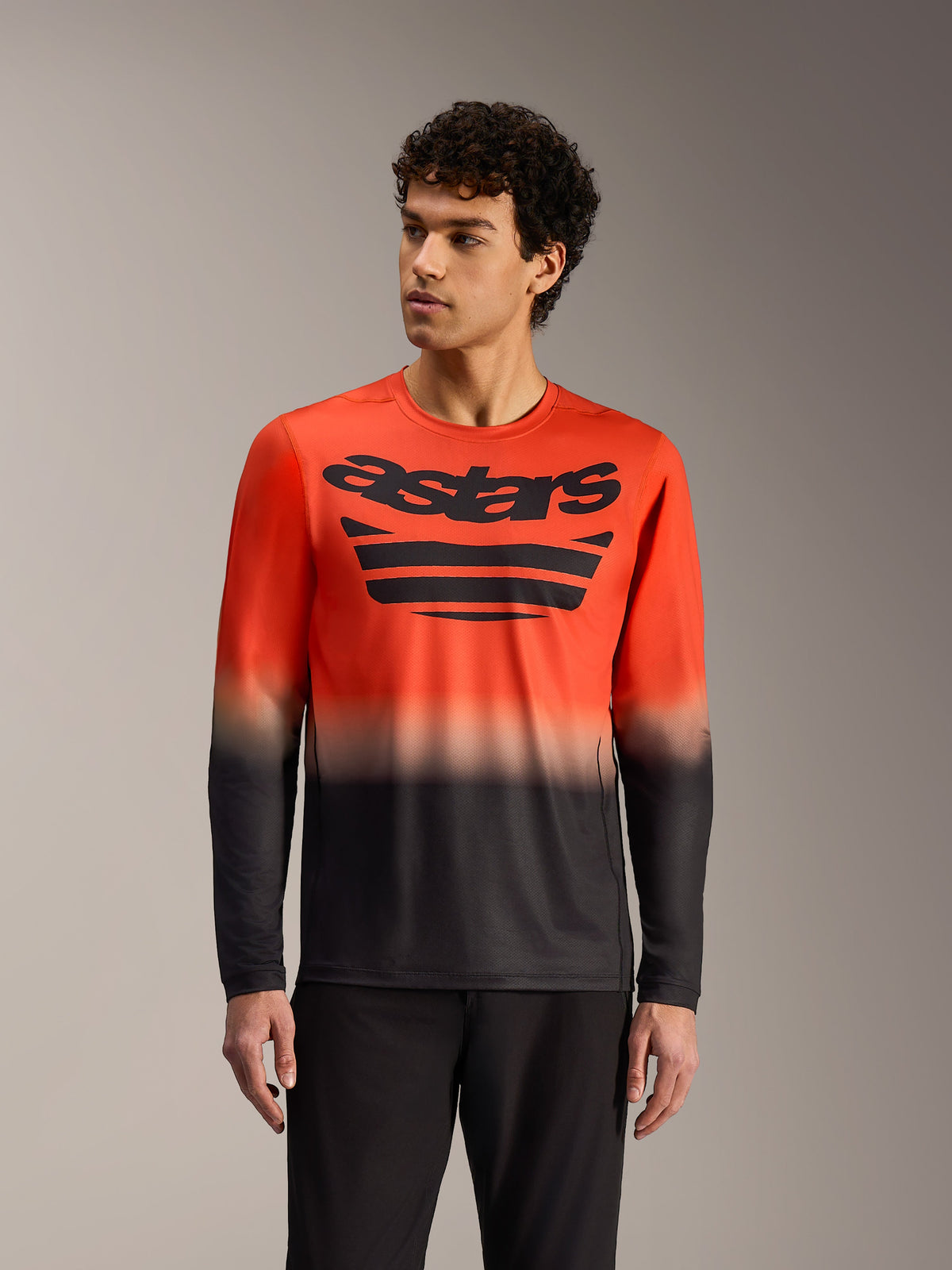 A-Dura ASTARS 2.0 Long Sleeve Jersey in orange and black gradient, featuring bold chest graphics for MTB performance.