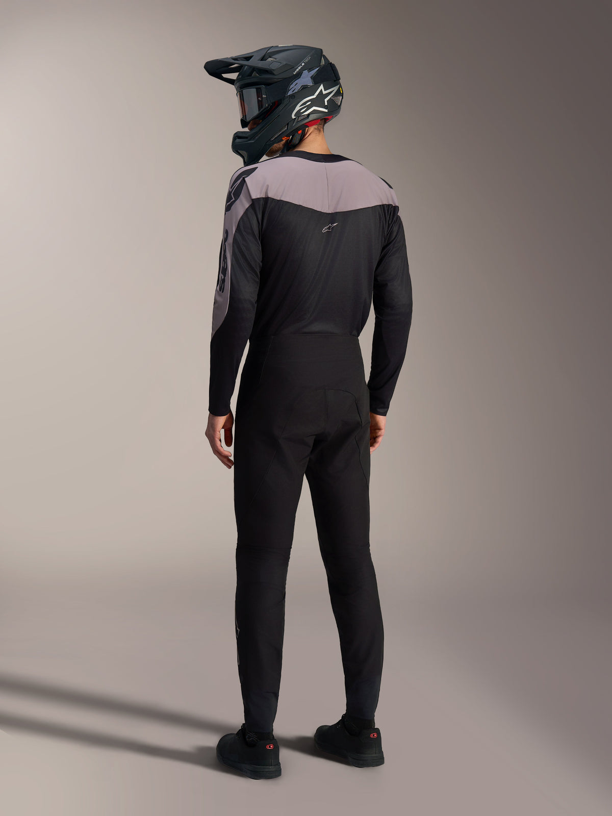 Alpinestars A-Supra Elite MTB kit in black and grey, featuring a performance jersey and matching racing pants from the back.