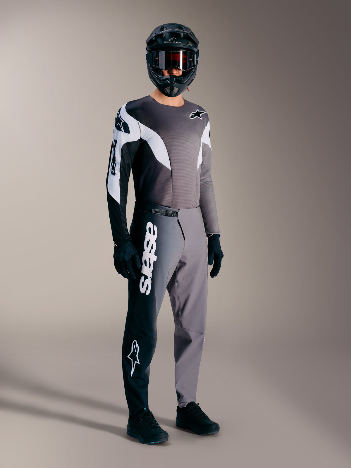 A-Supra Elite Jersey, Faded Gray long-sleeved MTB racing top with black and white accents on a rider in full gear.