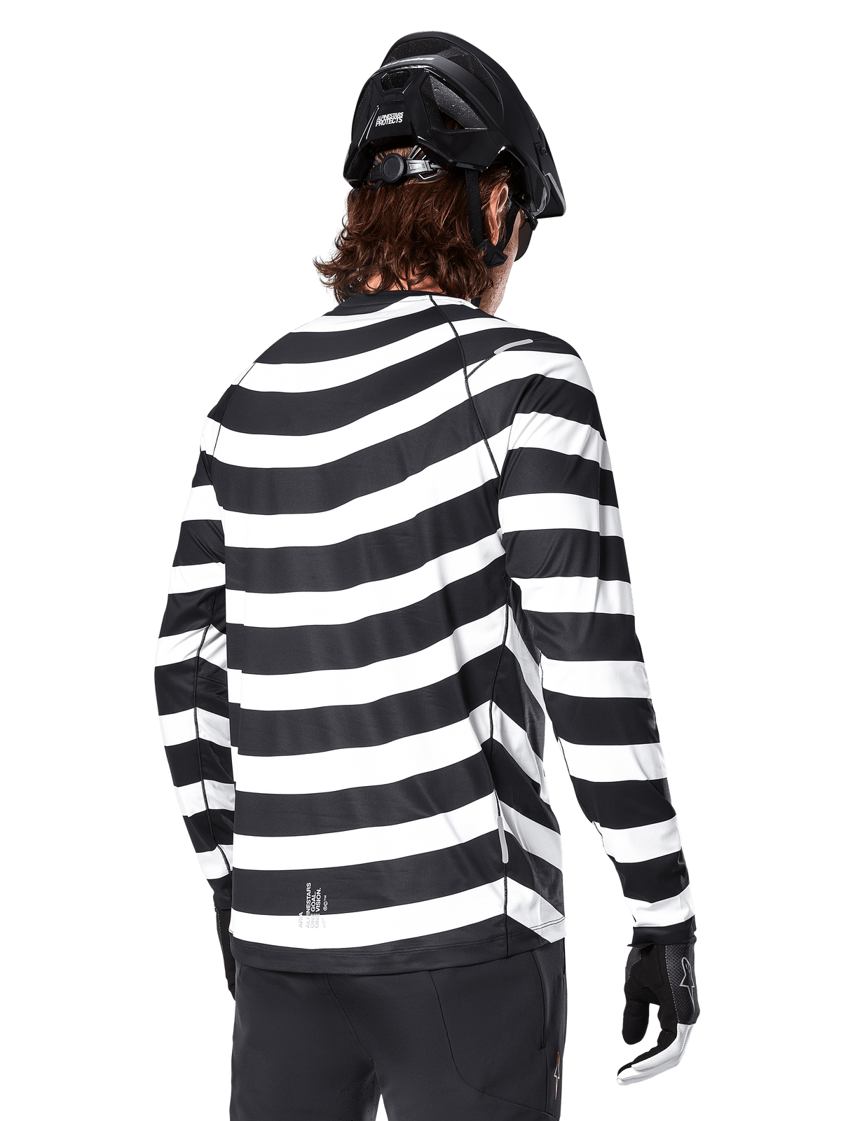 Alpinestars A-Aria Oscar Long Sleeve Jersey, back view, featuring bold black and white horizontal stripes, worn with a black mountain bike helmet and black pants, heritage-inspired performance MTB gear