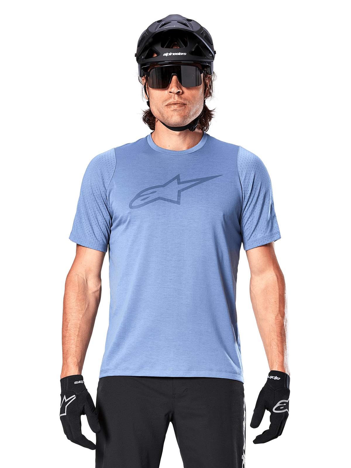 Male mountain biker wearing Alpinestars A-Dura Dri Astar Short Sleeve Jersey in Infinity Blue, featuring a subtle chest logo and mesh panels, paired with a black helmet, sunglasses, and black gloves for a technical cycling outfit
