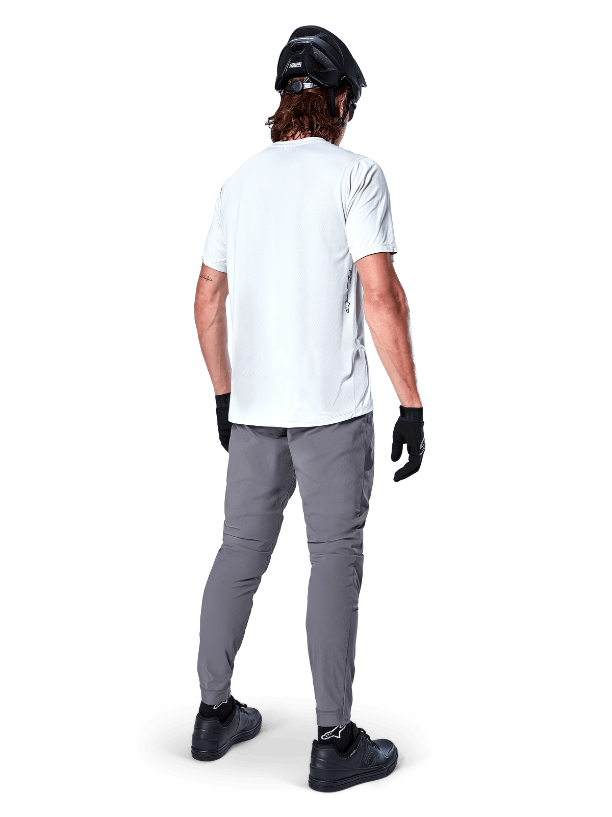 Alpinestars A-Dura Oscar Short Sleeve Jersey in White Dove, back view worn by a rider with grey cycling pants, black helmet, and gloves, technical mountain bike apparel for off-road trail riding