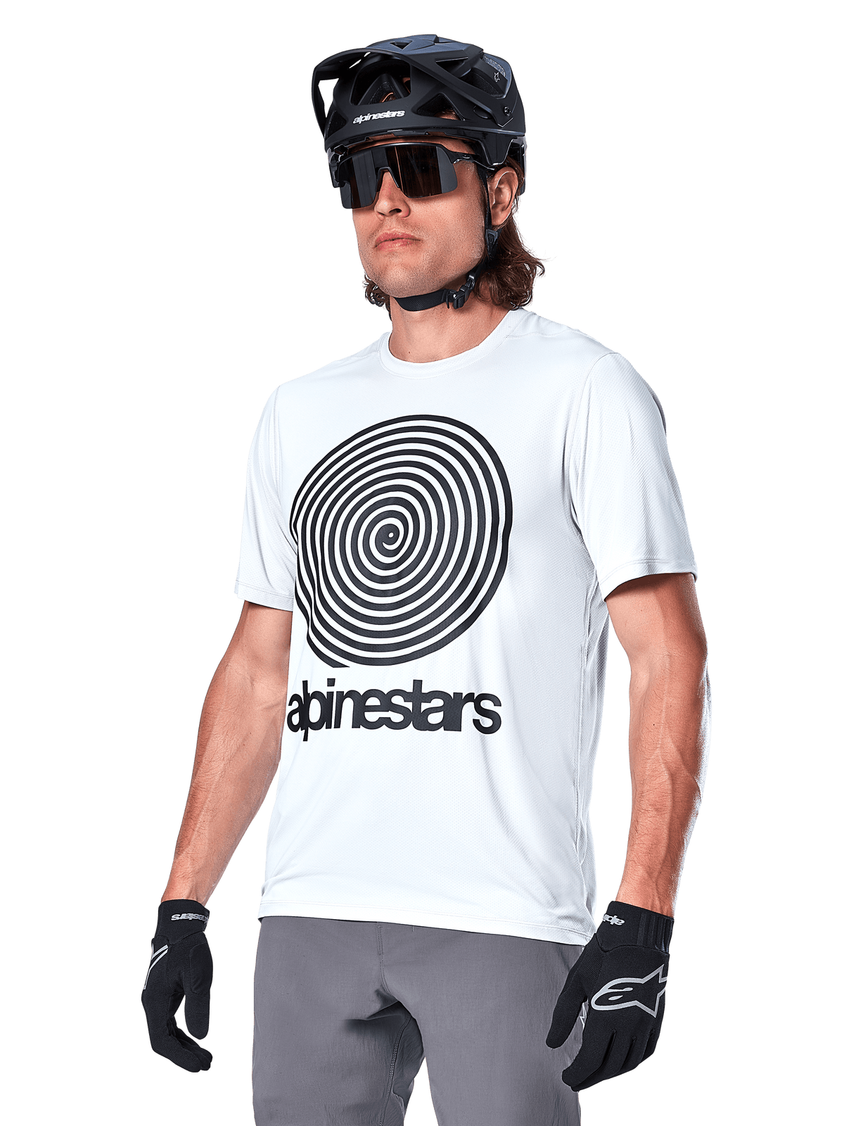 Alpinestars A-Dura Oscar Jersey - Short Sleeve, White Dove with black heritage spiral graphic and logo, worn with black MTB helmet and gloves, sporty performance mountain bike apparel