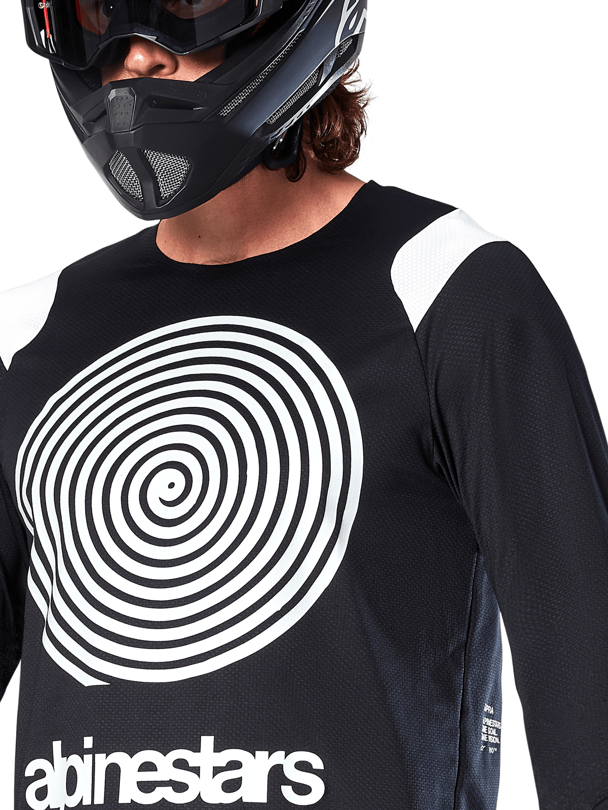 Alpinestars A-Supra Oscar Jersey, Long Sleeve, Black, featuring a large white Oscar spiral graphic on the chest and brand logo, worn by a rider with a black full-face helmet and goggles, performance mountain bike apparel for gravity riding