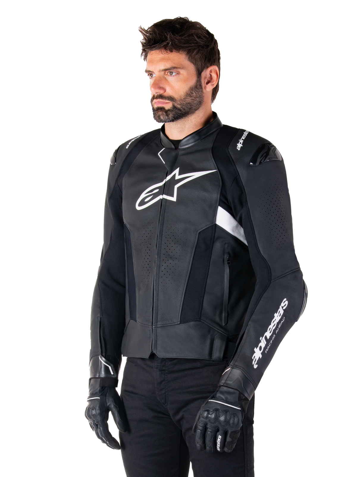 Alpinestars Missile V3 Leather Jacket, Black and White, worn by a man with black riding gloves, featuring a prominent white Alpinestars logo on the chest, external shoulder sliders, and perforated panels for a racing-inspired look.