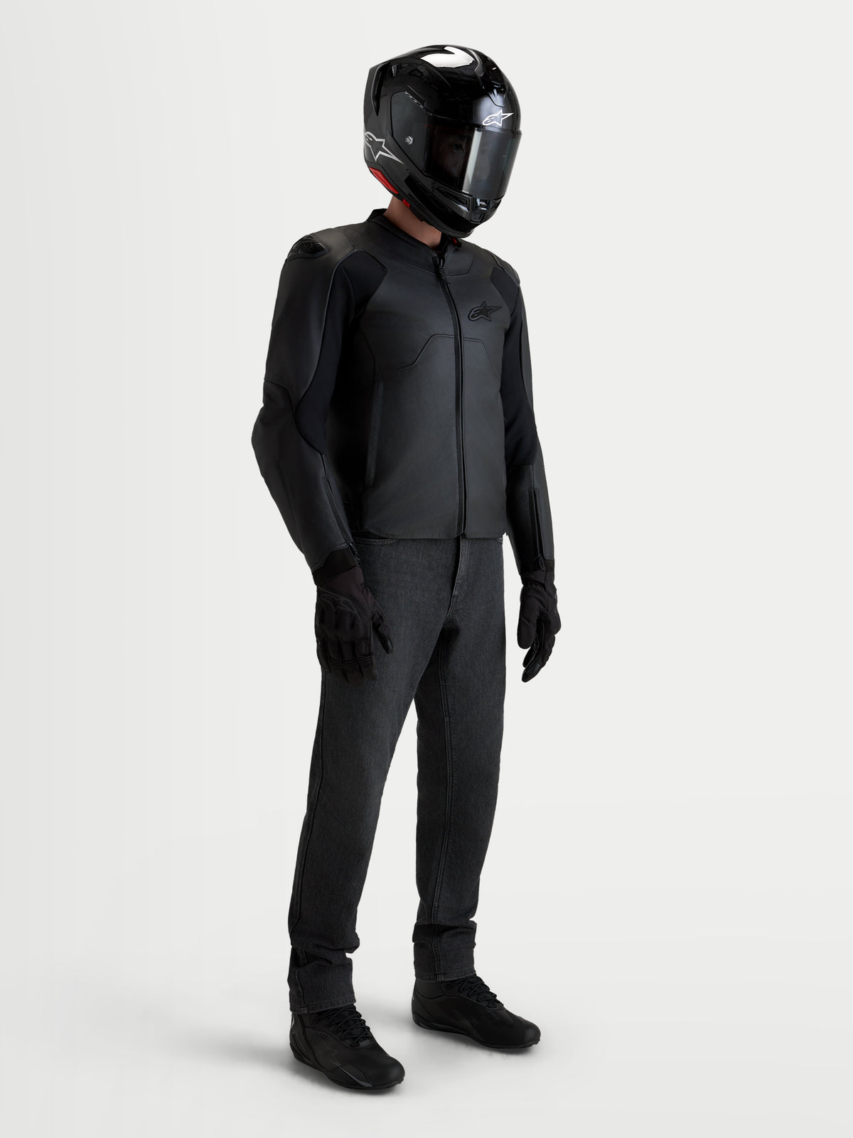 Alpinestars Caliber V2 Leather Jacket, Men's Black motorcycle leather jacket, worn by a rider with a matching black helmet, pants, and boots, featuring AA-rated protection and a streamlined sport fit for road riding