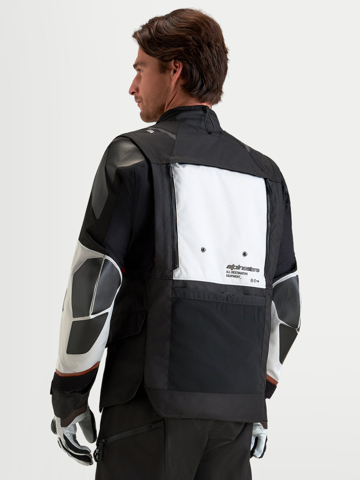 Alpinestars Harok V2 Drystar Jacket, Men's adventure motorcycle jacket in dark gray, ice gray, and black, featuring a modular ventilation system with foldable back panel, CE-certified protection, and recycled ripstop textile construction, shown from the back on a model