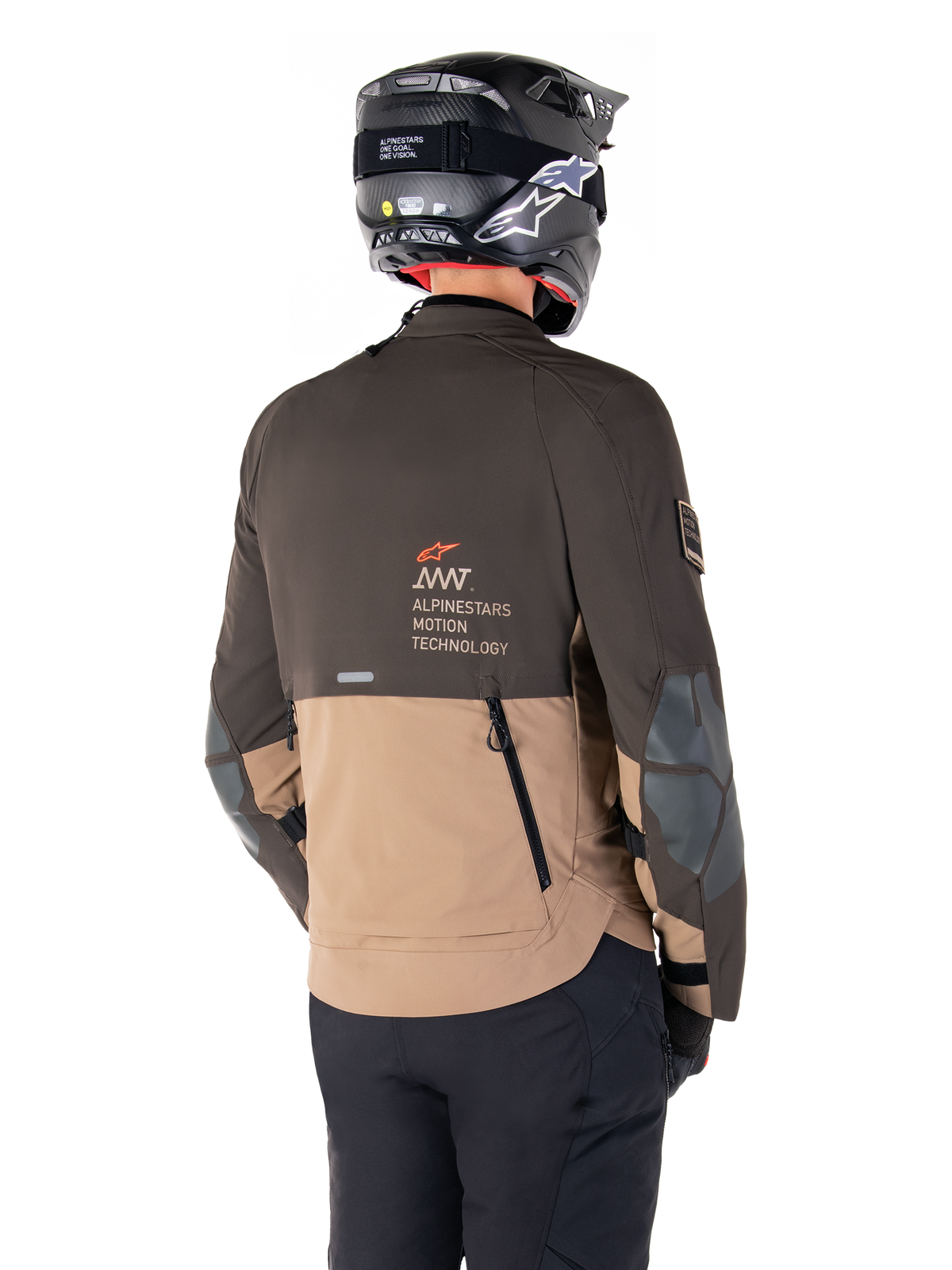 Alpinestars AMT-8 Stretch Drystar® XF Jacket, Adventure Motorcycle Jacket, Dark Brown and Dark Khaki, rear view showing AMT Alpinestars Motion Technology branding, two-tone textile design with back ventilation zippers and shingle-style exhaust, worn with black helmet and riding pants