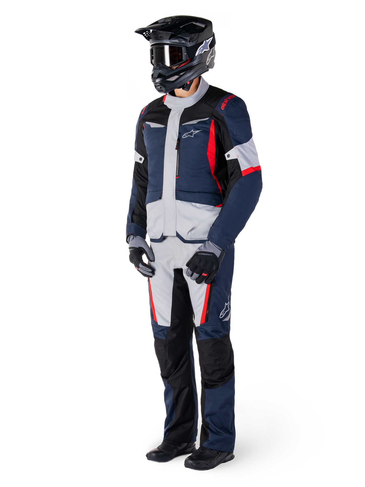 Alpinestars ST-1 Waterproof Jacket, Adventure Touring Jacket, Dark Blue Black and Bright Red, worn by a rider with matching pants, black adventure helmet, gloves, and boots, featuring grey panels and red accents, streamlined adventure-inspired design with Alpinestars logos