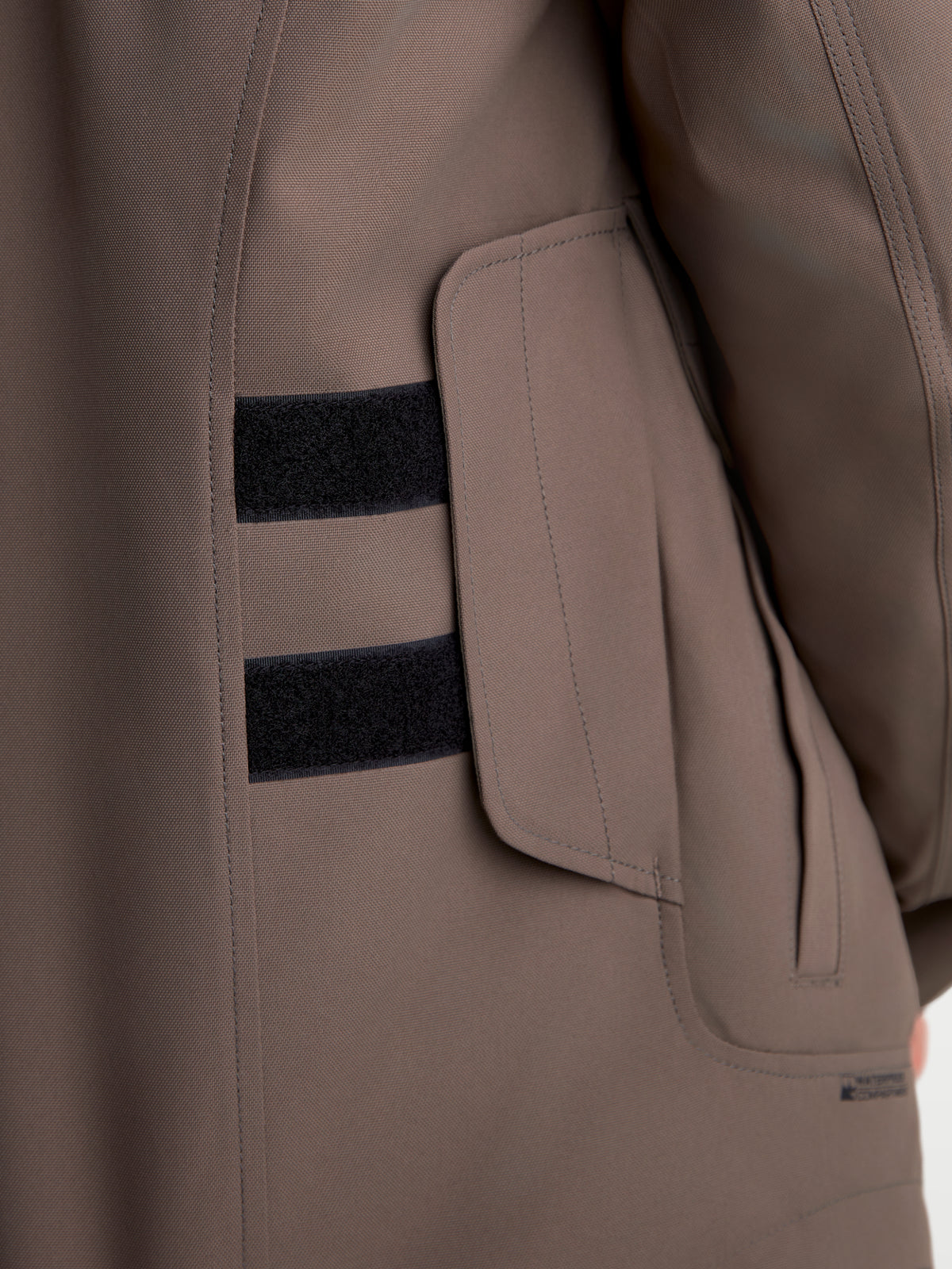 Alpinestars Altan Drystar Jacket, men's urban contemporary motorcycle utility jacket, walnut brown with black details, close-up view of side cargo pocket and adjustable waist straps