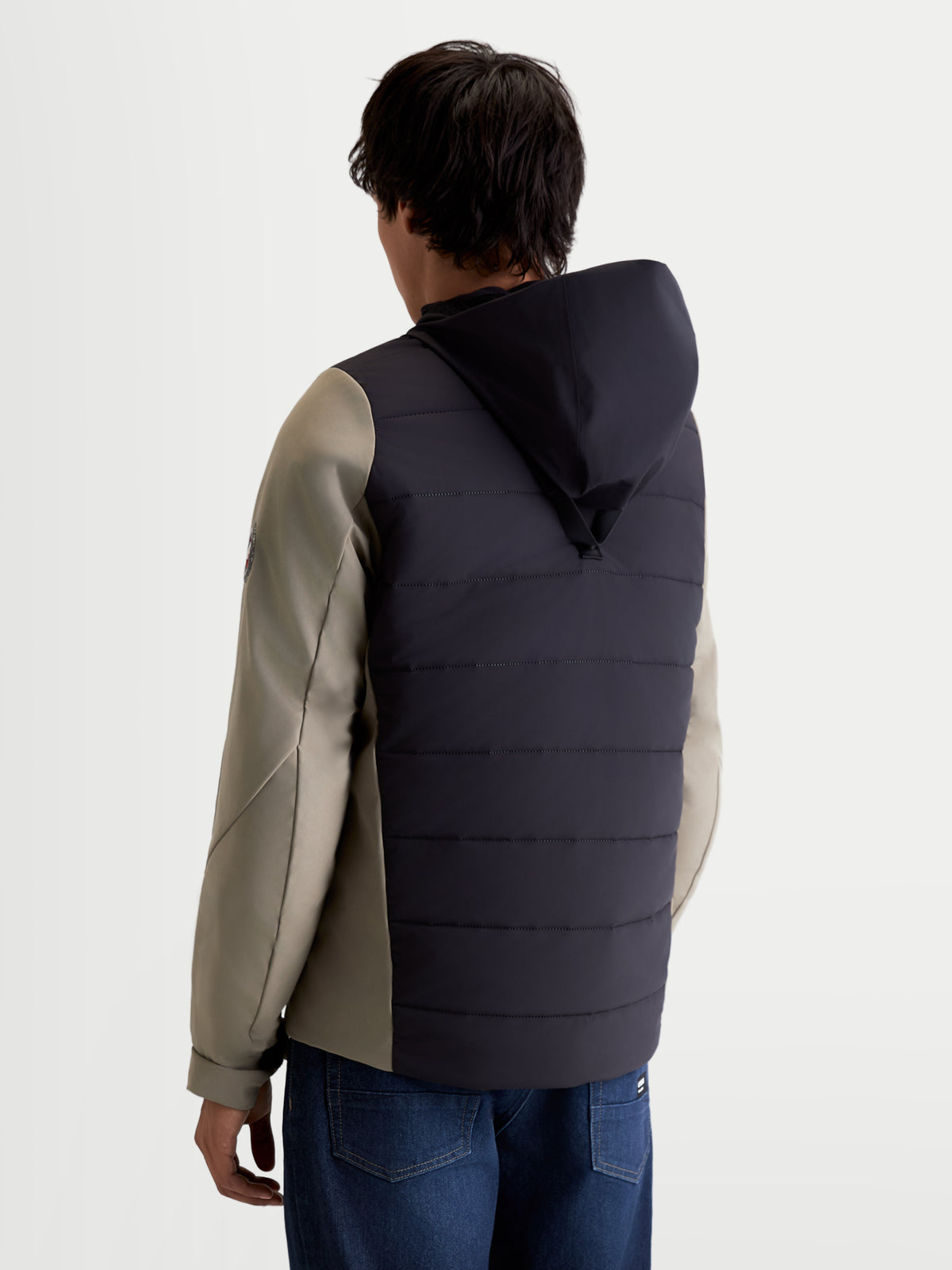 Alpinestars Therma-Tech Waterproof Jacket, men's urban contemporary motorcycle jacket in black and vetiver, rear view showing sonic-welded down construction and integrated hood system worn by a model.