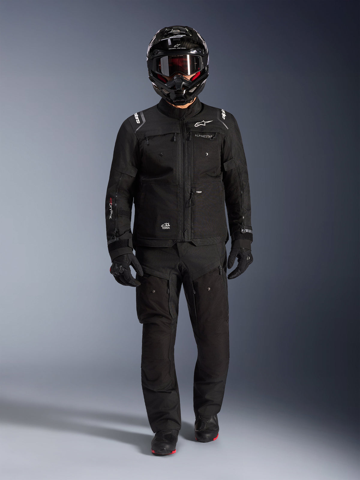 Alpinestars Cusco Drystar® Jacket, black men's adventure touring jacket in ripstop, worn with matching pants and helmet.