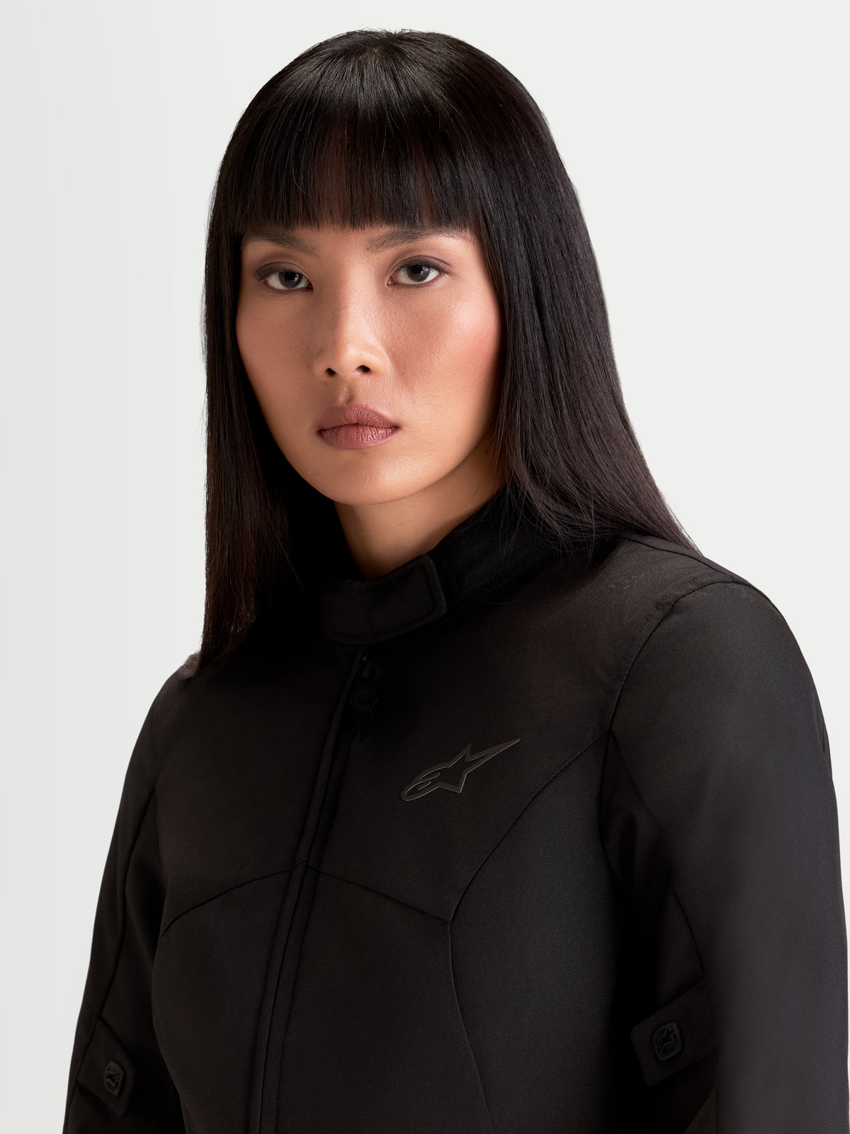Alpinestars Stella C-1 Waterproof Jacket, women's urban motorcycle textile jacket, black, close-up portrait view showing the soft inner collar and polyfabric construction worn by a model