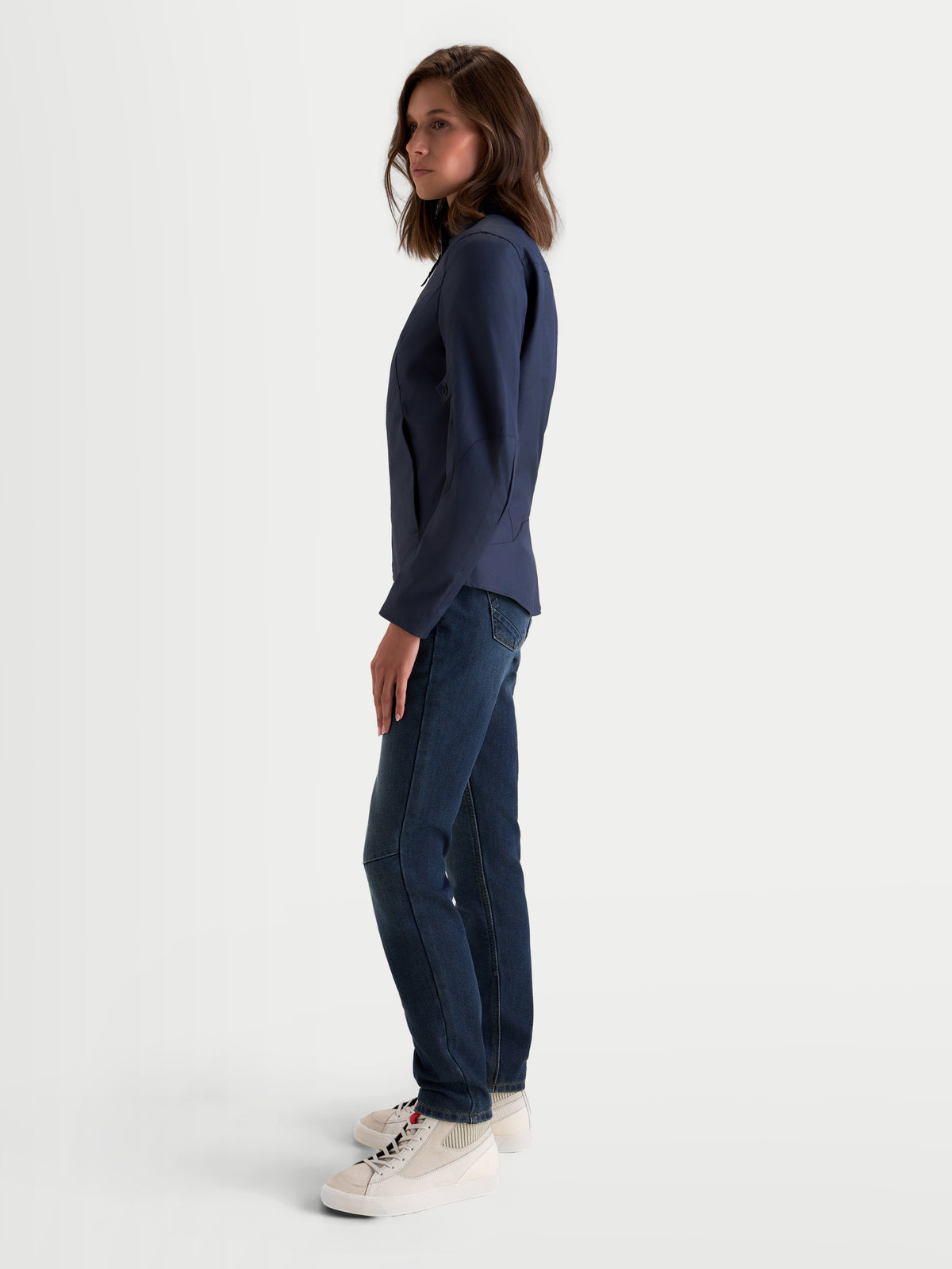 Alpinestars Stella C-1 Waterproof Jacket, women's urban motorcycle jacket in mood indigo, side profile view worn by a model with jeans and casual sneakers, showcasing waterproof textile construction and ergonomic fit.