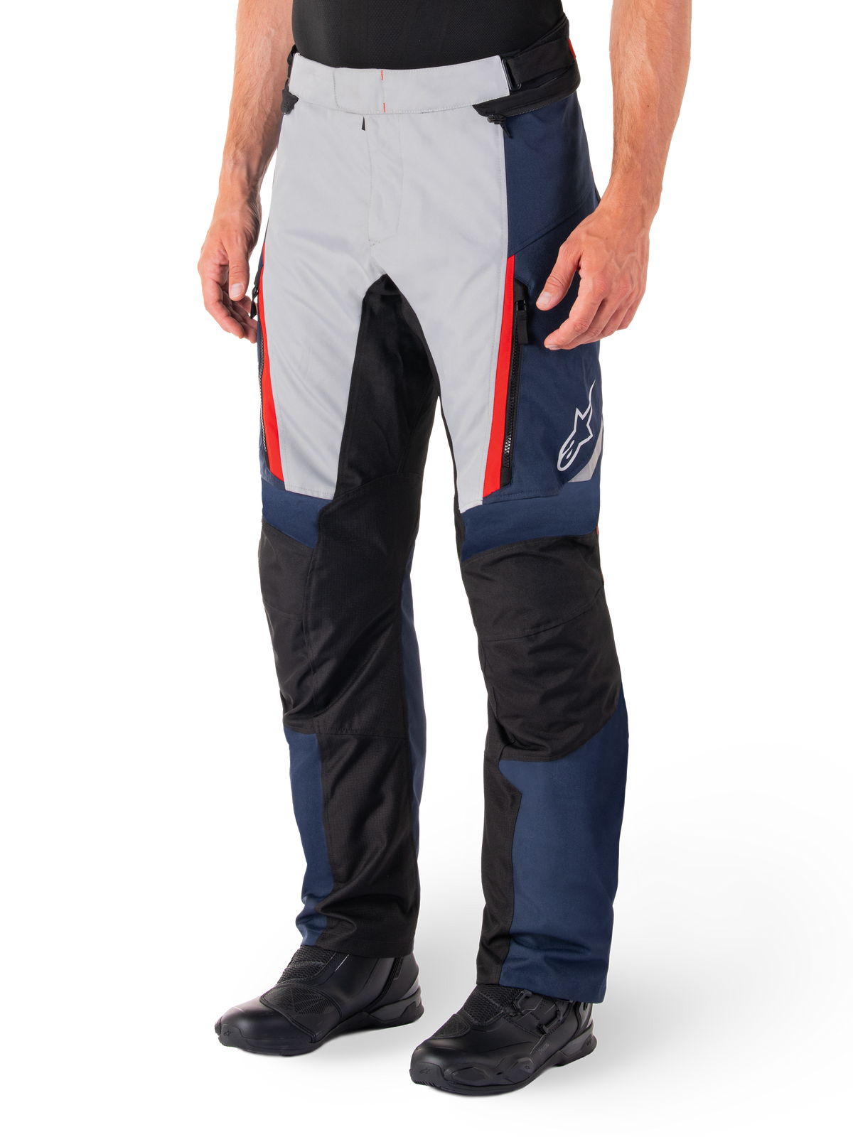 Alpinestars St-1 Waterproof Pants, Motorcycle Touring Pants, Dark Blue Black and Bright Red, featuring light grey front panels with red zipper accents, black reinforced knee sections, and a white Alpinestars logo on the side, worn with black motorcycle boots.