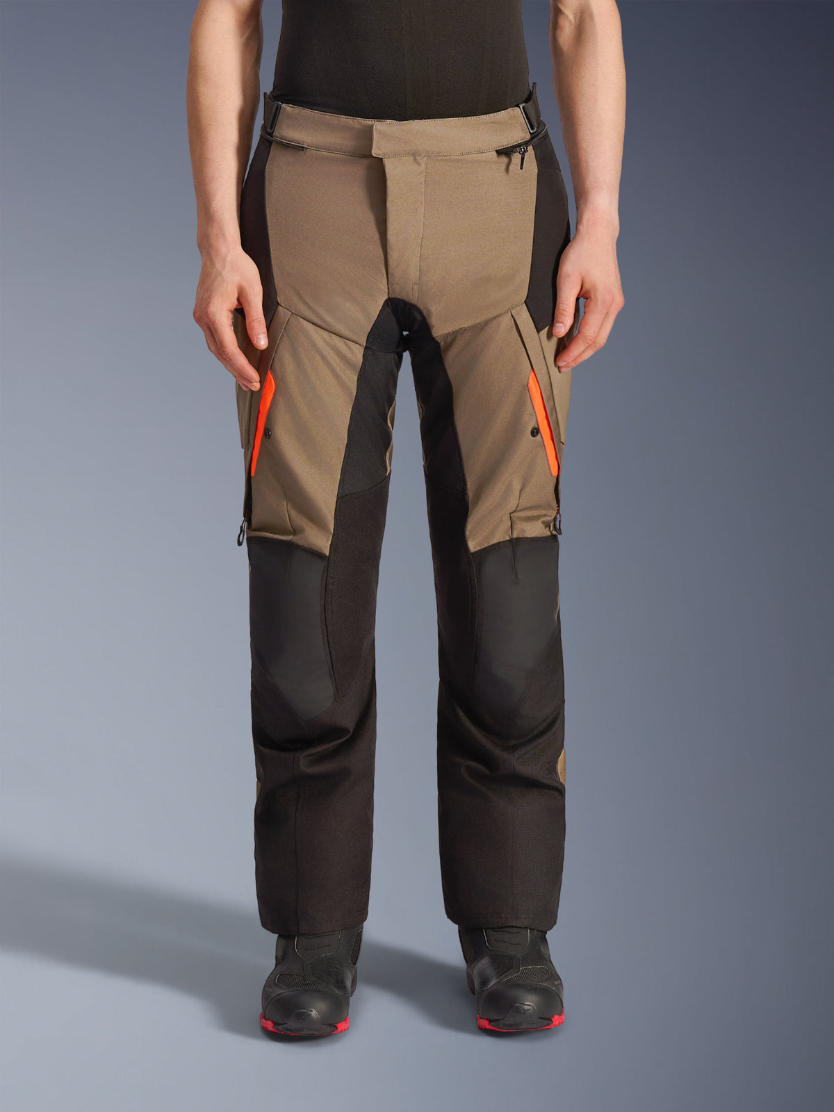 Alpinestars Andes V4 Drystar® Pants, Walnut and Black motorcycle adventure touring pants, featuring bright orange thigh zippers, reinforced black knee panels, and durable textile construction for all-weather riding.