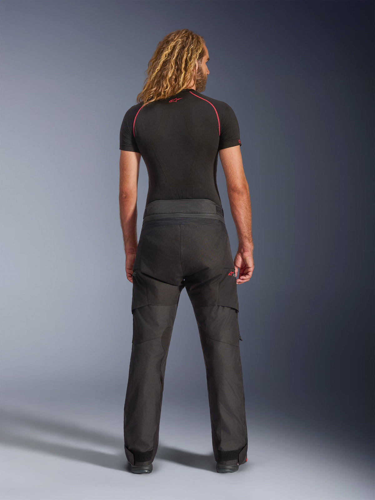 Alpinestars Andes V4 Drystar® Pants, Adventure Motorcycle Pants, Black, rear view worn by model with black base layer, featuring durable textile construction and ripstop reinforcements for all-weather riding