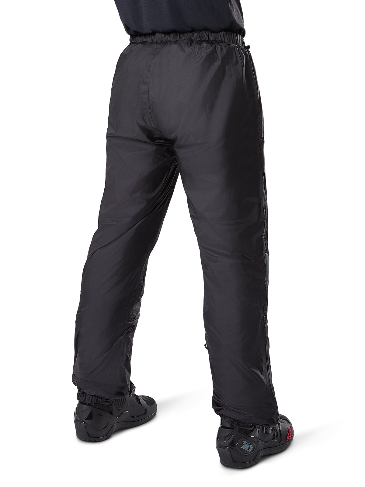 Alpinestars Bogota' Pro Drystar® 3 Seasons Pants, Black adventure touring motorcycle pants, rear view of the waterproof Drystar® liner worn as over-pants, paired with black motorcycle boots, technical lightweight construction for multi-season weather protection