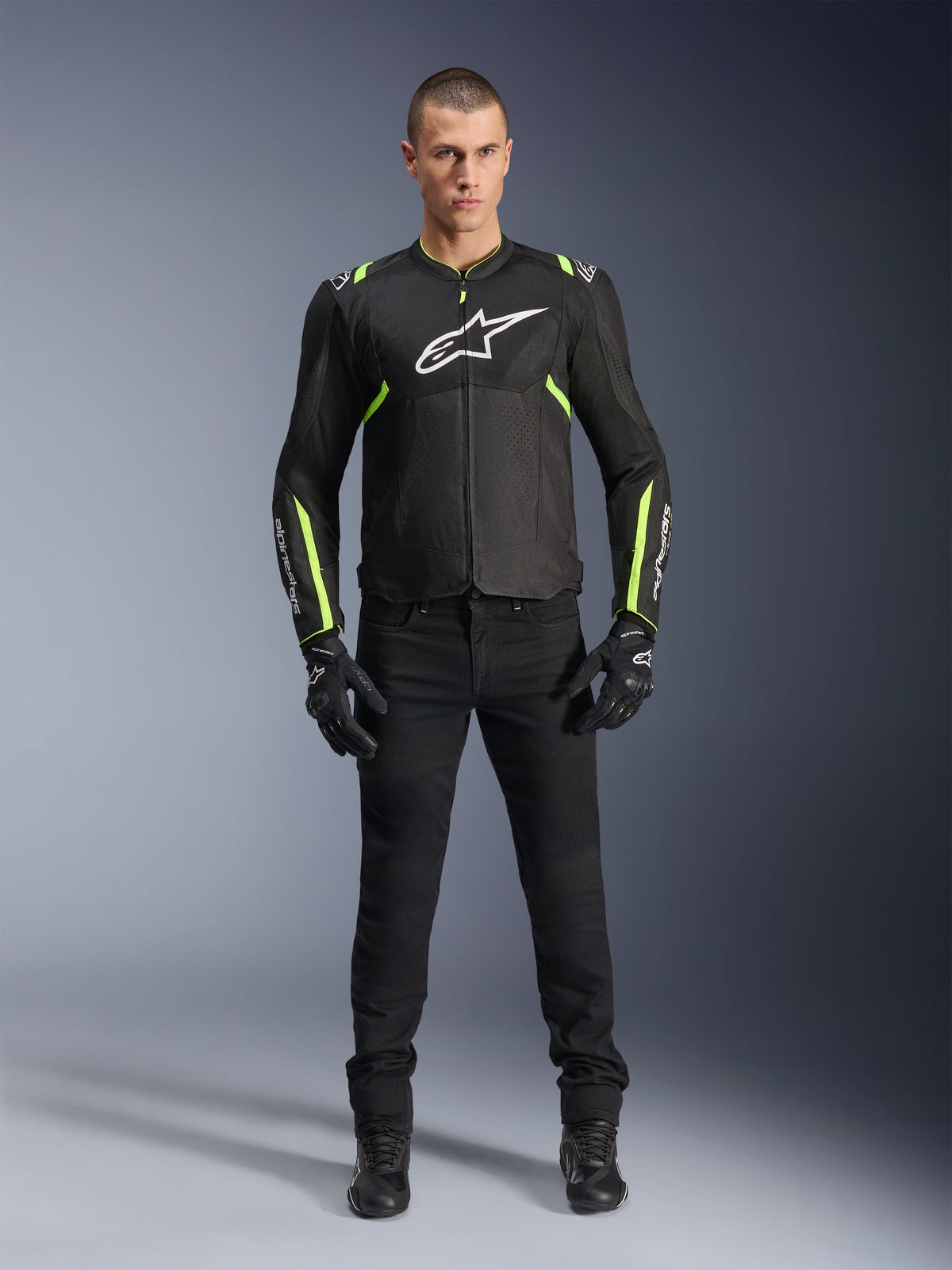 Alpinestars T-Sps Air V2 Jacket, Black and Yellow Fluo, textile motorcycle jacket with mesh paneling, worn by male model with black pants and gloves, featuring white Alpinestars logo on chest, urban sport riding gear