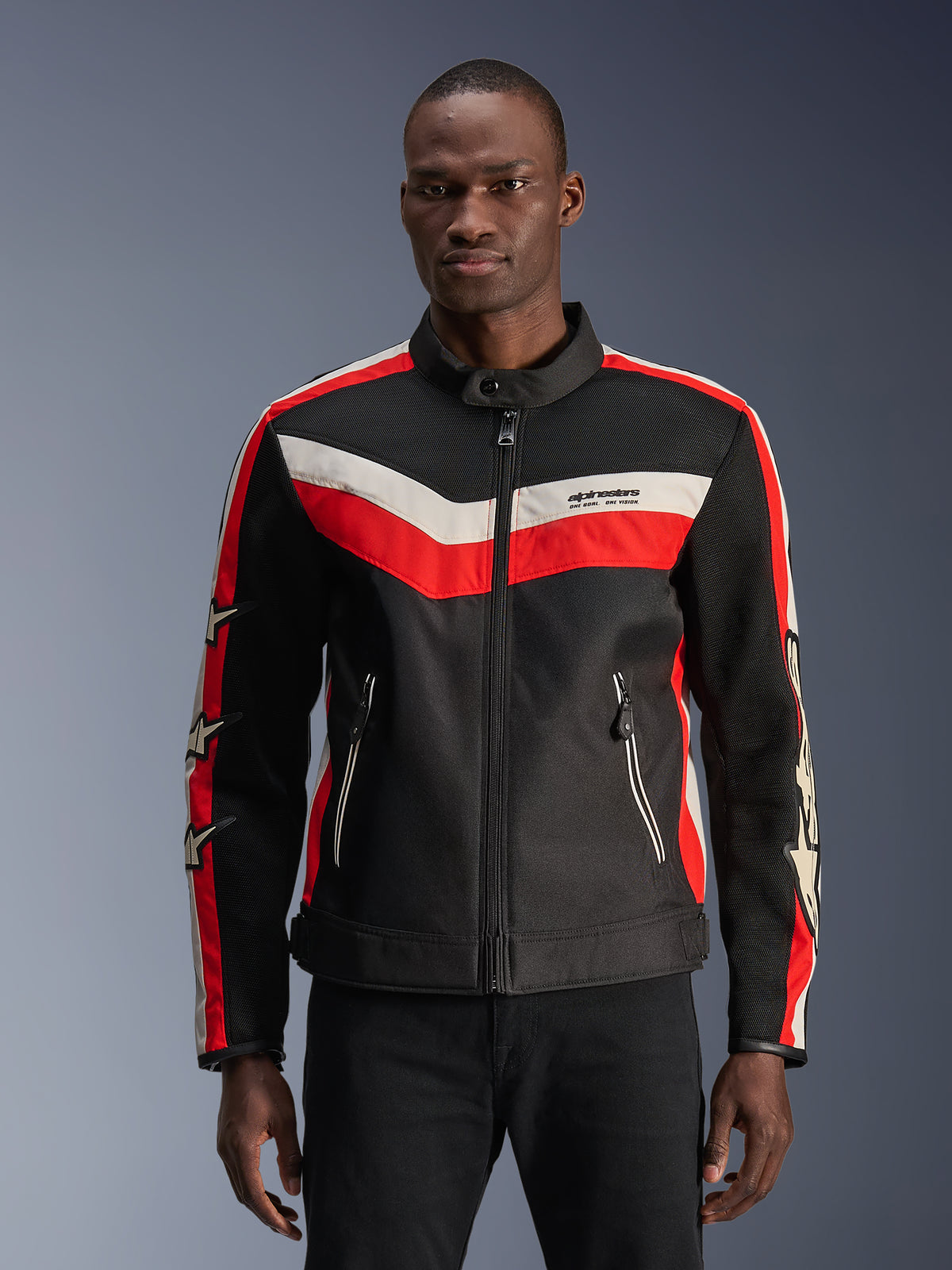 Alpinestars T-Dyno Air Jacket, Black with Bright Red and Ecru chevron stripes, featuring star accents on sleeves, high collar with front zipper, zippered hand pockets, vintage-inspired textile motorcycle jacket design