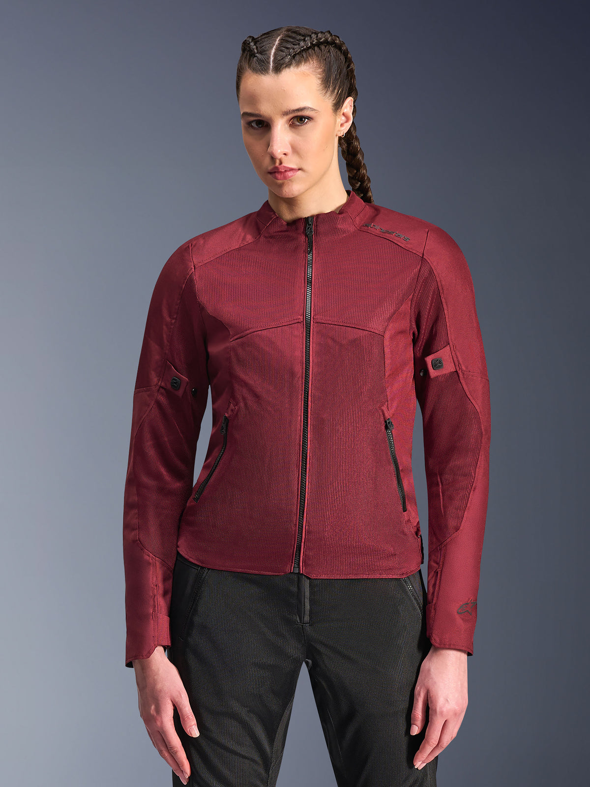 Alpinestars Stella C-1 Air Jacket, Women's Motorcycle Jacket, Burgundy Red, mesh panels for airflow, zippered front and pockets, fitted sporty design, worn by a model with black riding pants