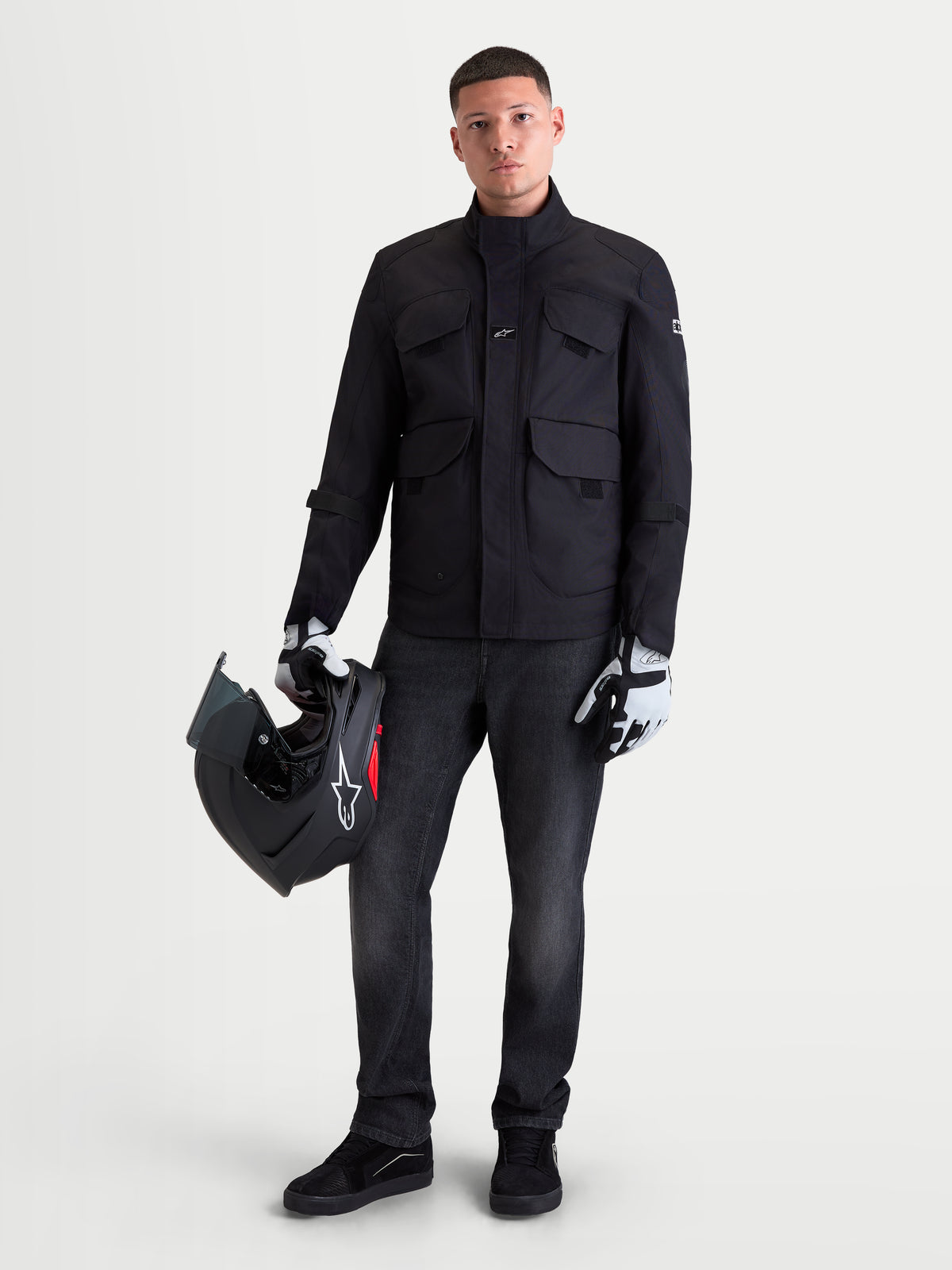 Alpinestars Flex-AST 8 Denim Pants, men's urban contemporary motorcycle riding denim in used black, worn by a model holding a helmet and matching apparel