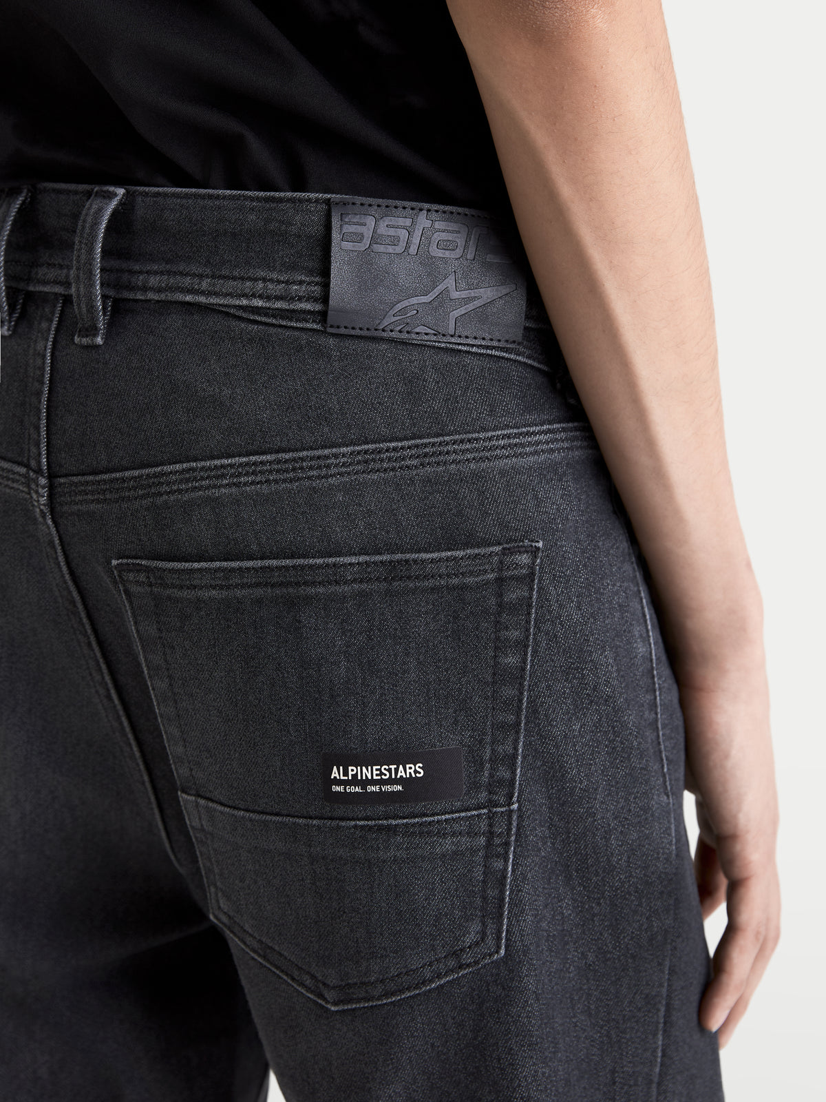 Alpinestars Flex-AST 7 Denim Pants, men's urban motorcycle riding jeans, faded black, close-up view of the back pocket, leather back patch, and Alpinestars branding detail