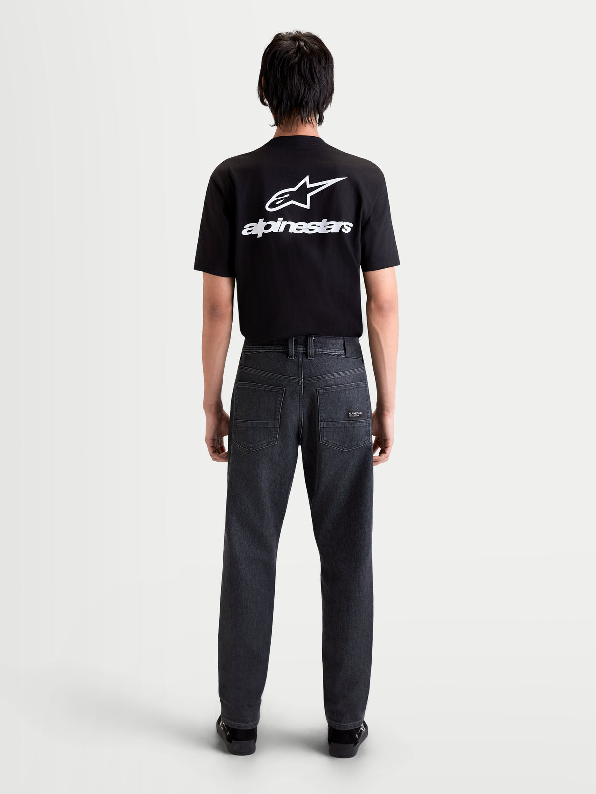 Alpinestars Flex-AST 7 Denim Pants Short, men's urban motorcycle denim pants in faded black, rear view on a model wearing a black t-shirt, showing single-layer technical denim construction and regular tapered fit