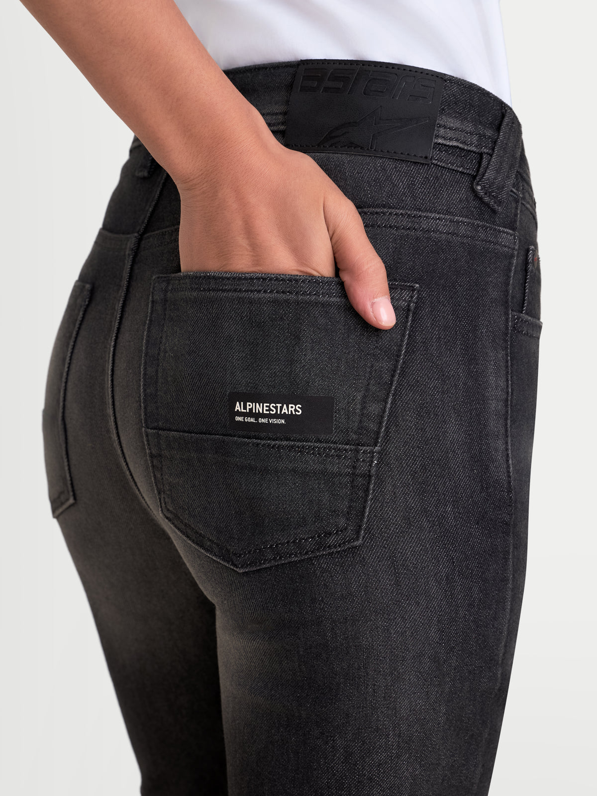 Alpinestars Stella Flex-AST 7 Denim Pants, women's urban contemporary motorcycle riding pants in faded black, close-up view showing the back pocket detail and leather waistband patch