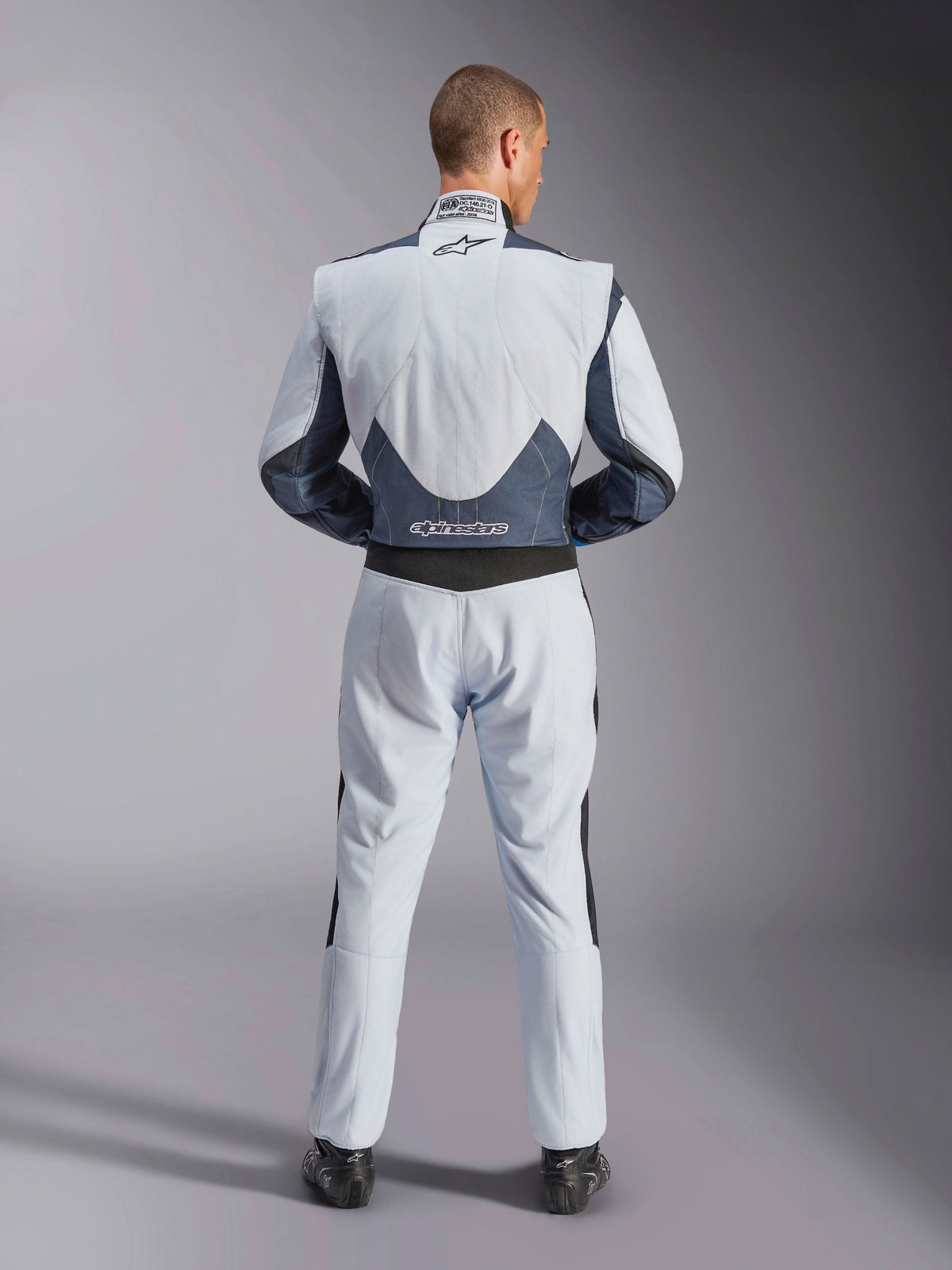 Alpinestars GP Pro Comp V2 FIA Suit, Gray and Black Auto Racing Suit, back view showing FIA certification and stretch panels.