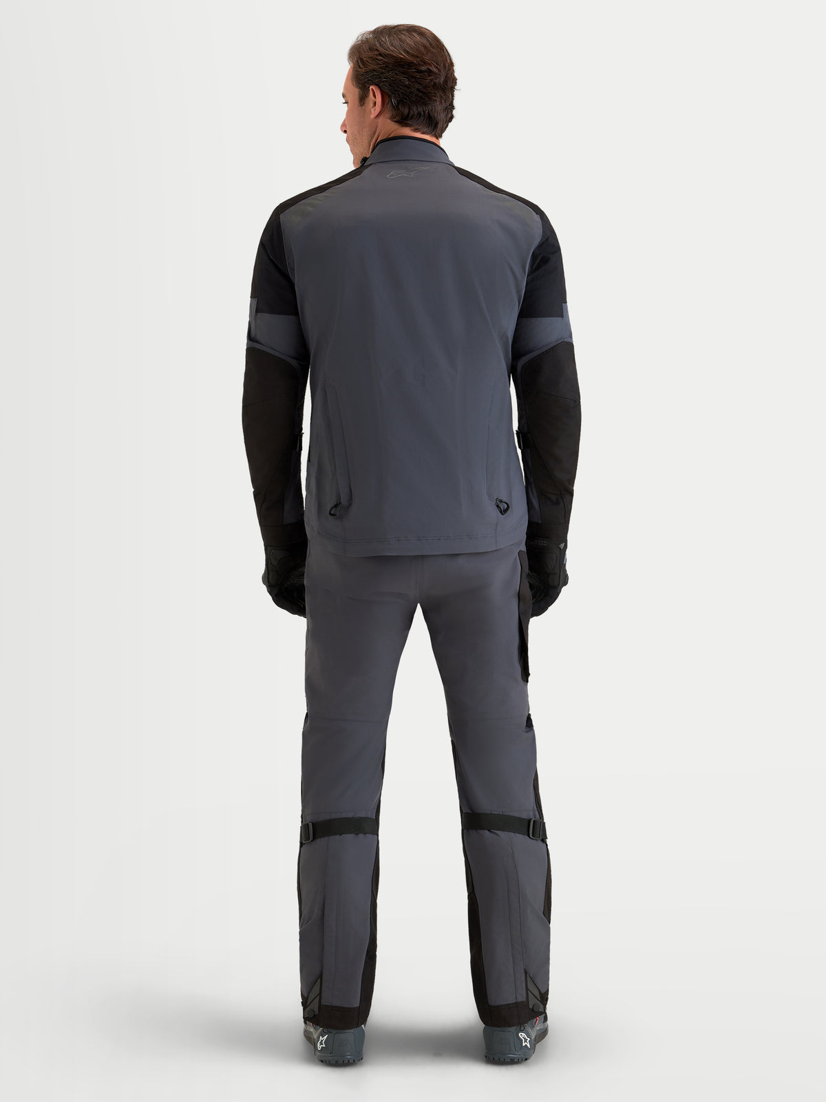 Alpinestars Arenis Gore-Tex Jacket, men's all-terrain adventure touring motorcycle jacket in black and deep gray, rear view showing waterproof textile shell construction and integrated rear exhaust vents.