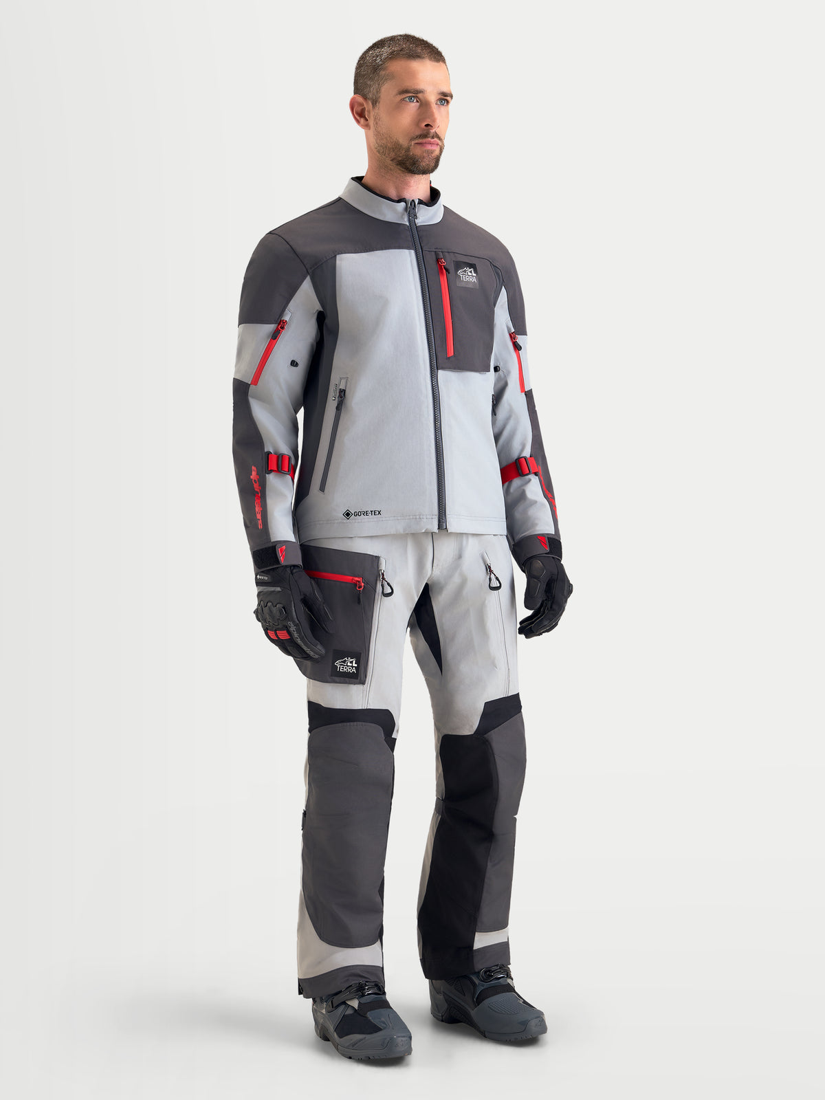 Alpinestars Arenis Gore-Tex Gear Set, men's adventure touring motorcycle jacket and pants in light gray and dark gray with red accents, front view on a model wearing matching waterproof textile riding apparel