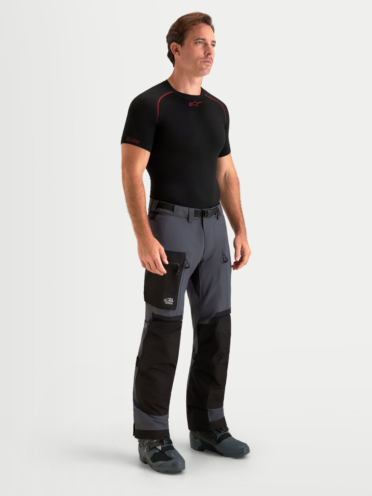 Alpinestars Arenis Gore-Tex Pants, men's adventure touring motorcycle pants in black and deep gray, front view on a model wearing matching gear and waterproof textile construction.
