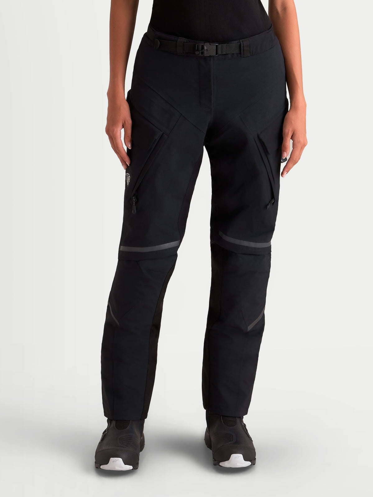 Alpinestars Stella St-7 V2 2L Gore-Tex Pants Short, women's adventure touring motorcycle pants in black, front view on a model wearing waterproof textile riding gear with cargo pockets and magnetic waist buckle.