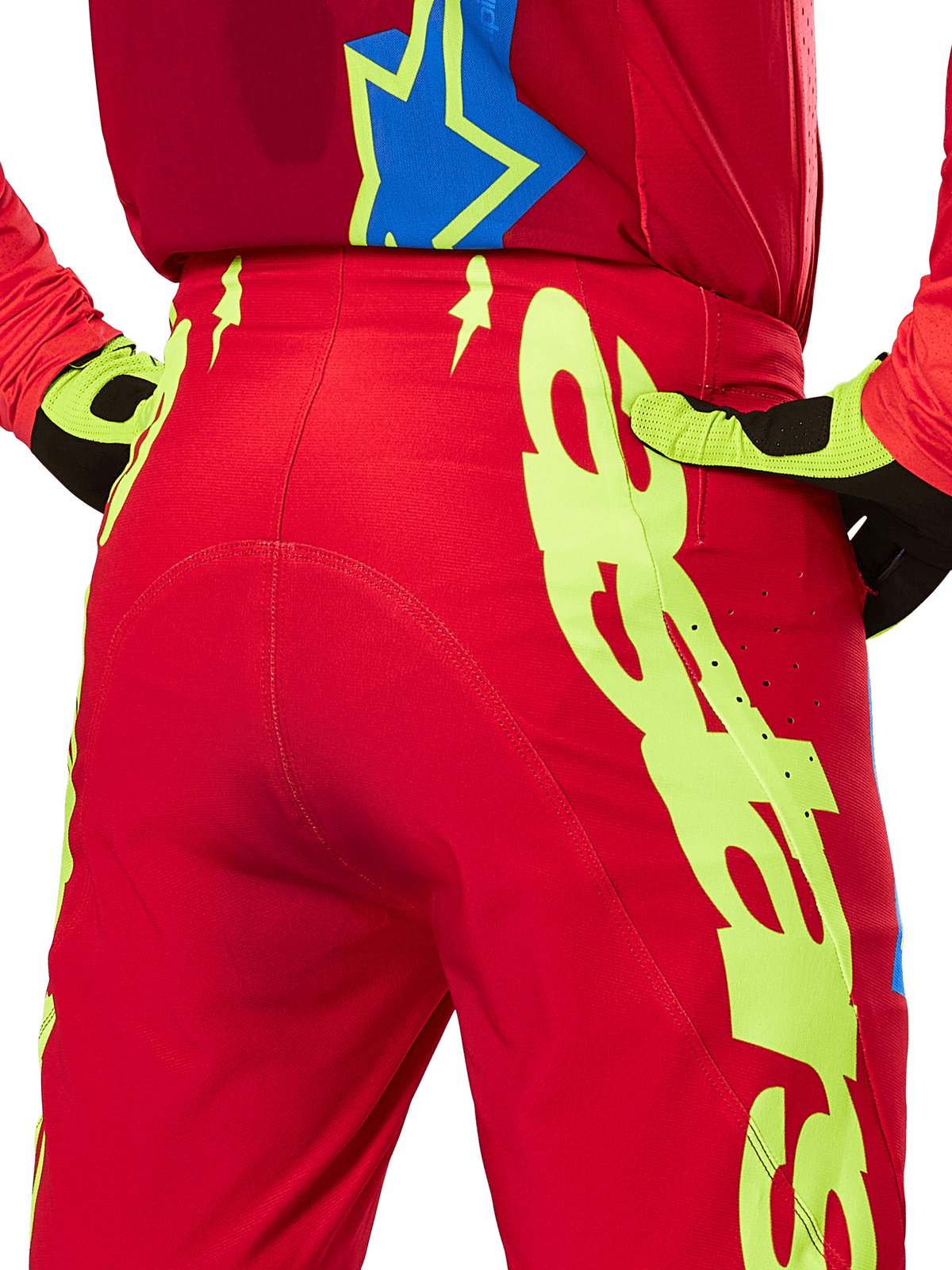 Alpinestars 2025 Supertech Maker Pants, Motocross Pants, Bright Red and Yellow Fluo, rear close-up showing bold neon yellow graphics, worn with matching red jersey and yellow/black gloves